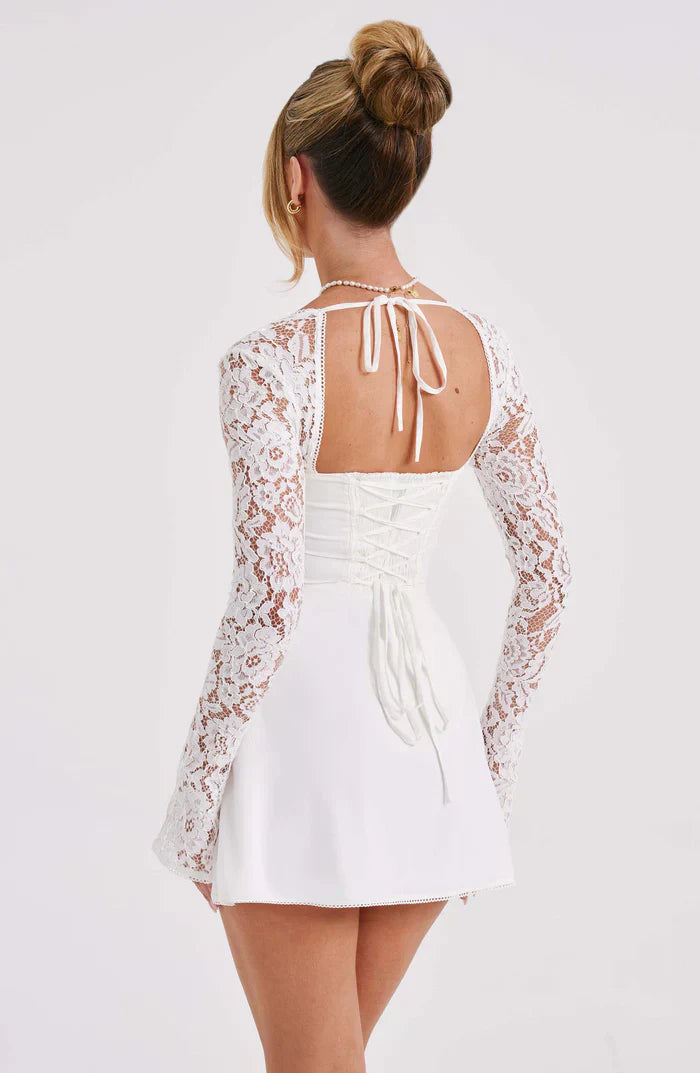 Back view of the white Gemma Tie Mini Dress, showing the lace-up corset detail and tie-neck closure.