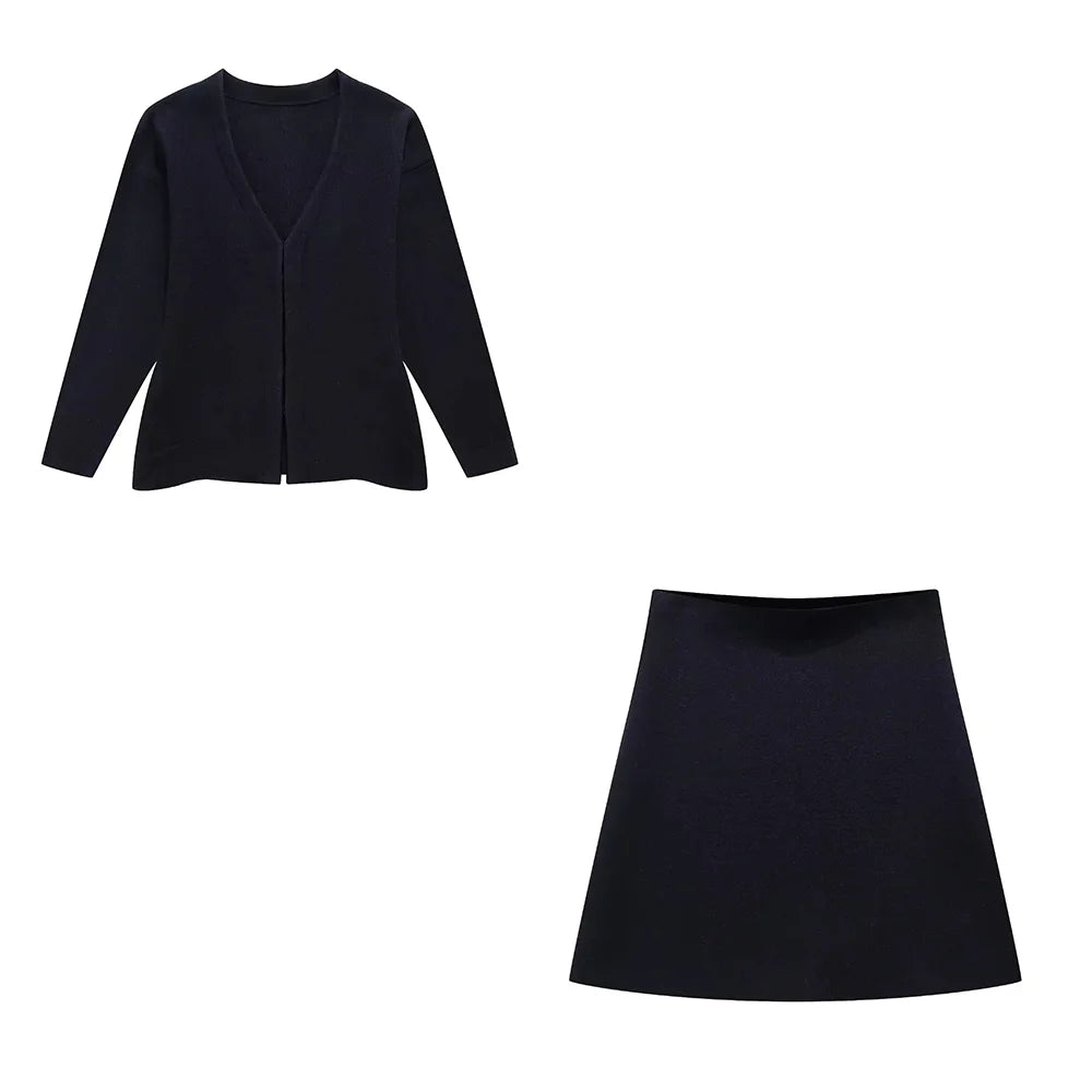 Flat lay of a black knit mini skirt and a matching long-sleeved v-neck cardigan, highlighting the simple design.
