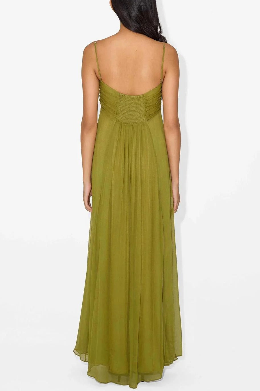 Back view of the olive green maxi dress, highlighting the smocked back detail and delicate spaghetti straps.