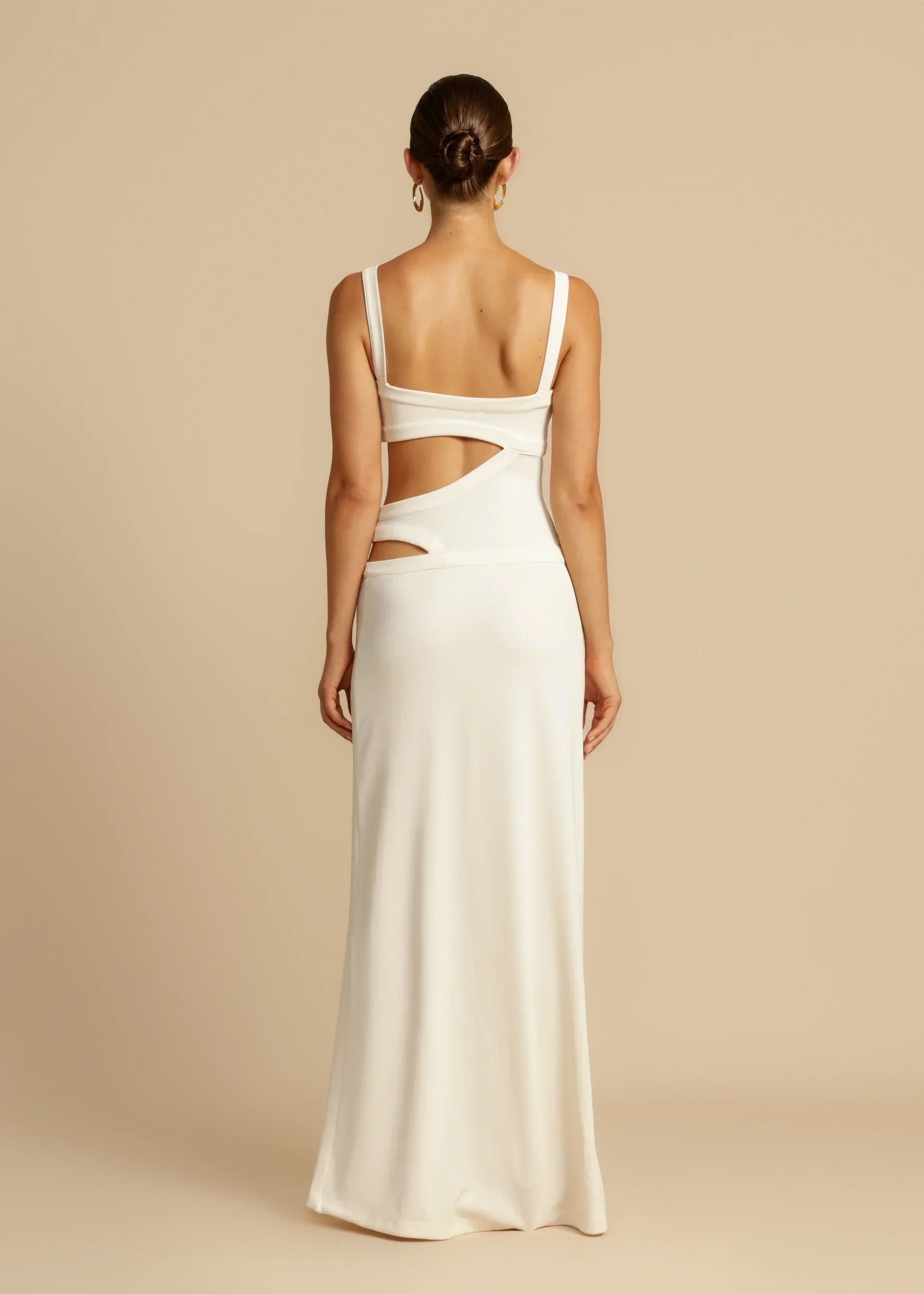 Rear view of the white Haisley cutout maxi dress, highlighting the elegant back design and flowing skirt.