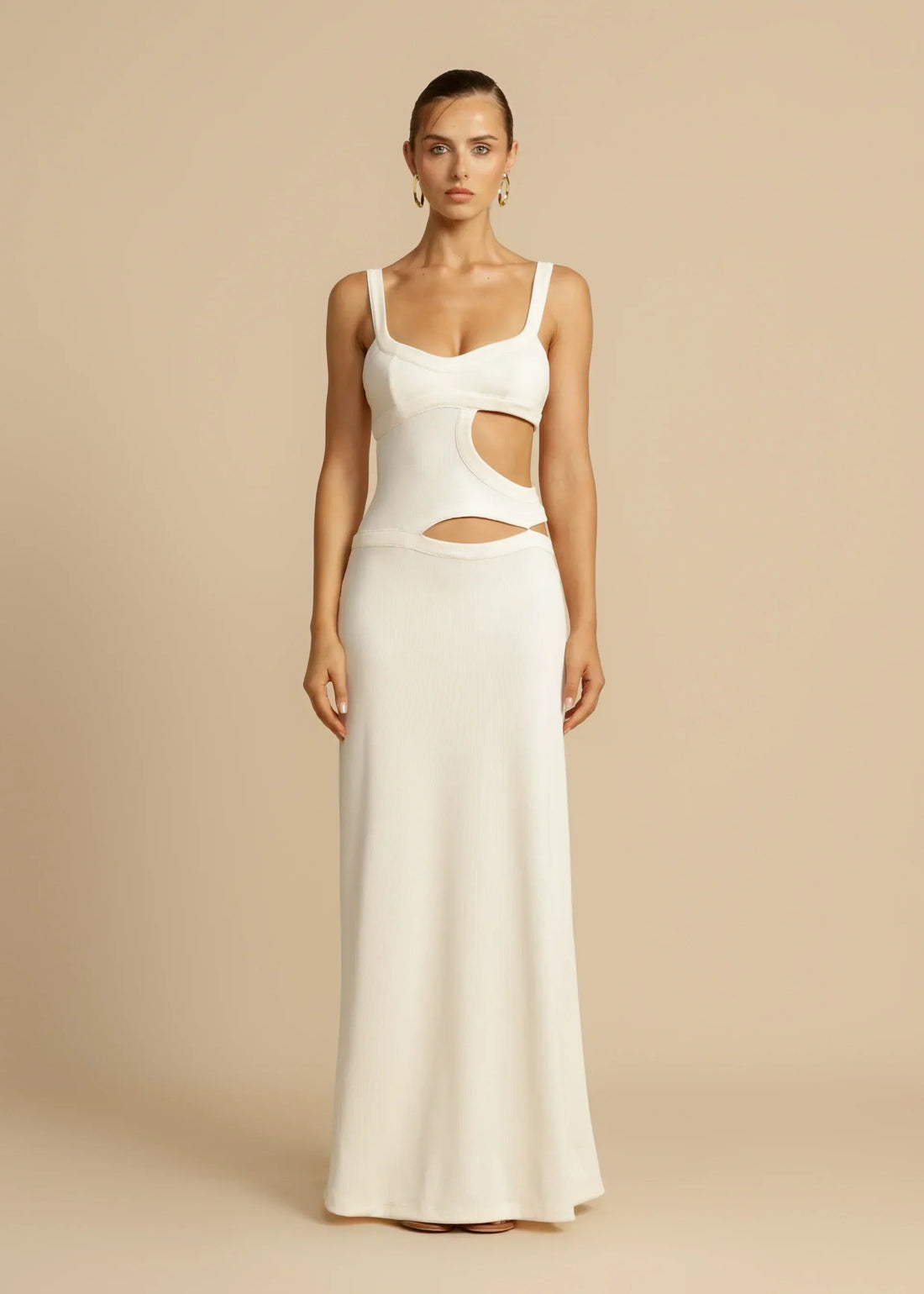 Full-length white Haisley cutout maxi dress with thick straps and side cutouts, on a light background.
