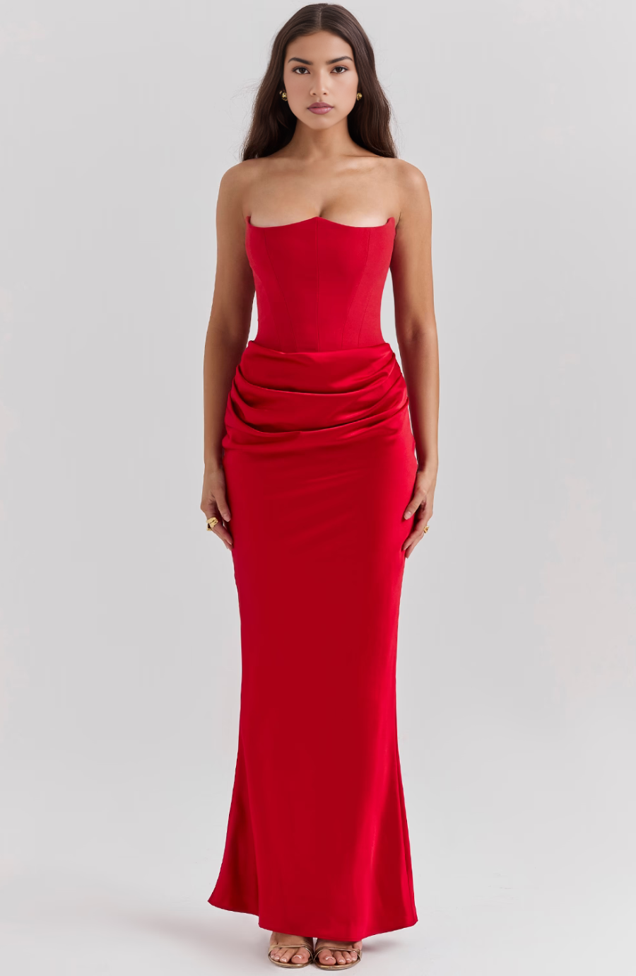 Full length front view of the Hazel corset maxi dress in a striking red color, with a tailored bodice and flowing skirt.