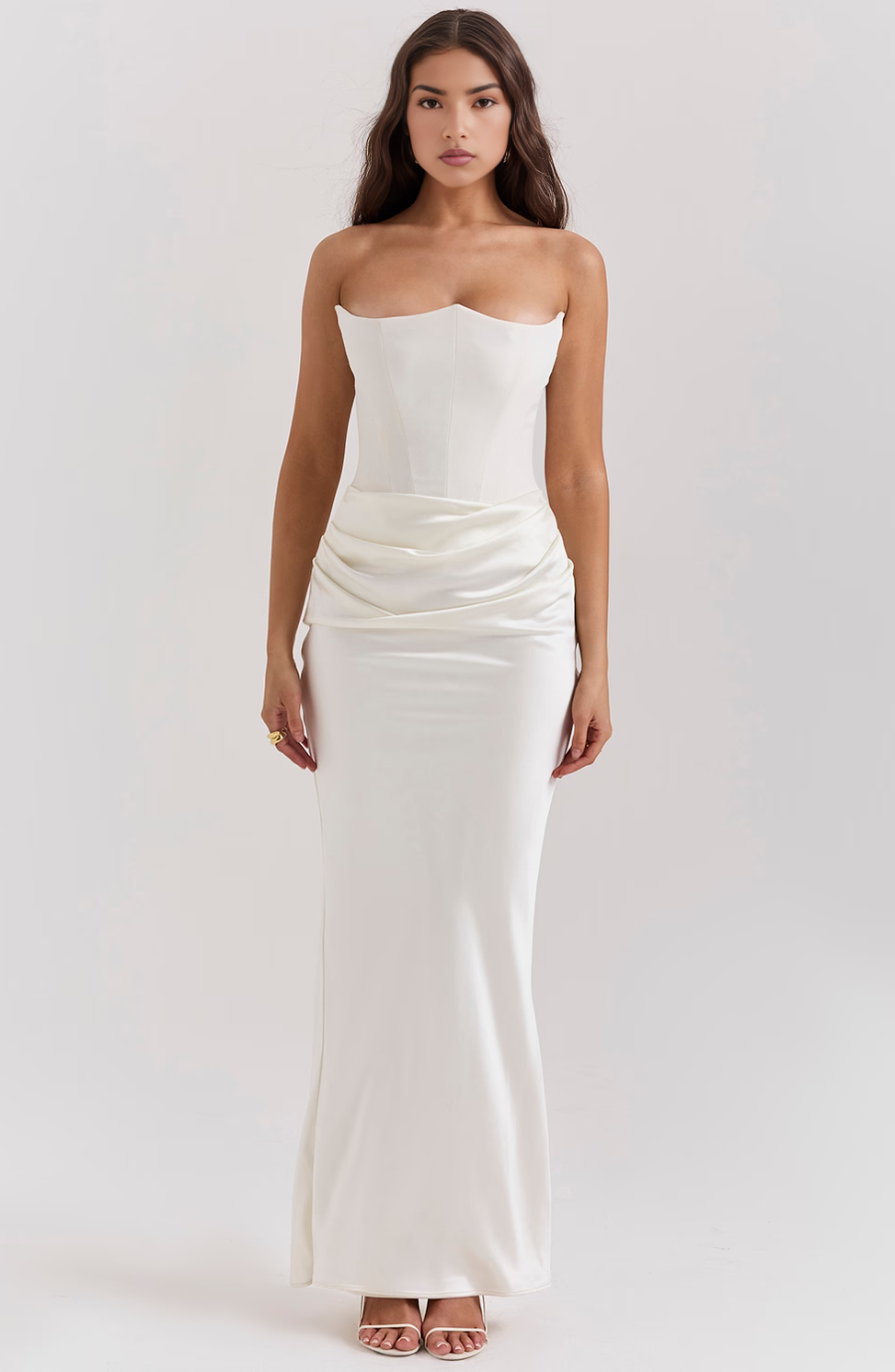 Full-length white corset maxi dress with a structured bodice and flowing skirt, perfect for a wedding or formal event.