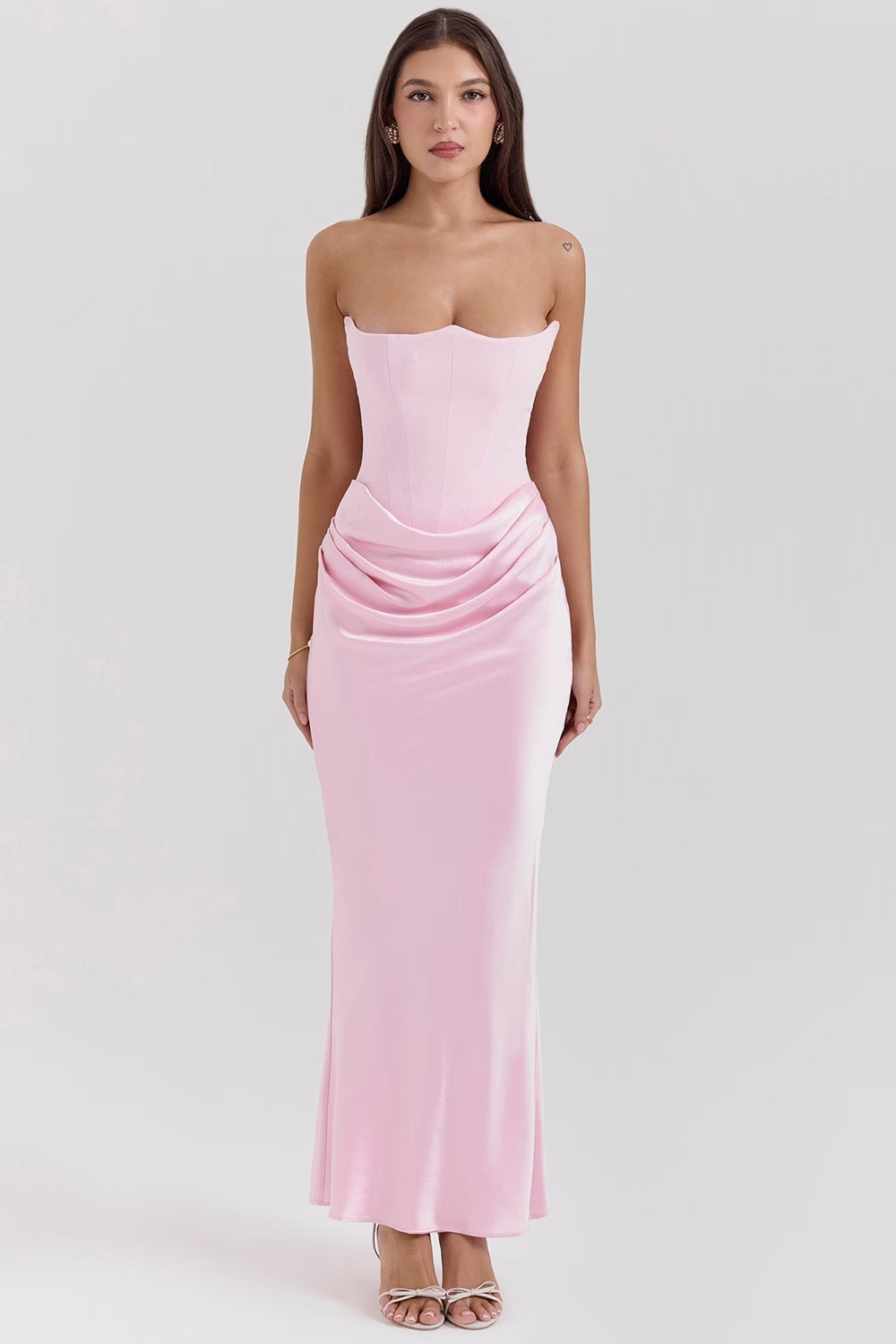 Front view of the Hazel corset maxi dress in light pink, featuring a fitted bodice and flowing skirt.