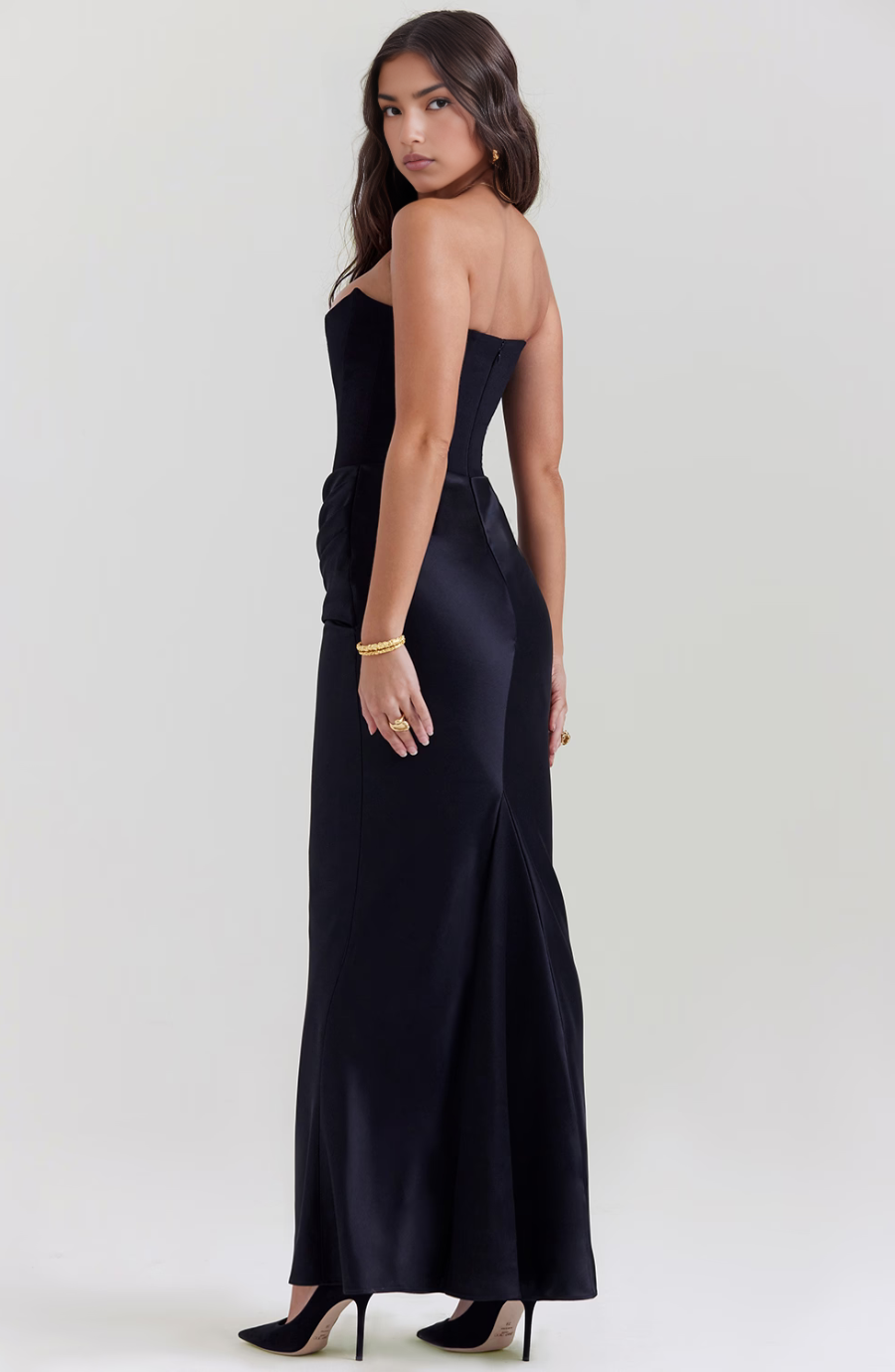 Back view of the black strapless corset maxi dress, showing the fitted silhouette and a subtle train.