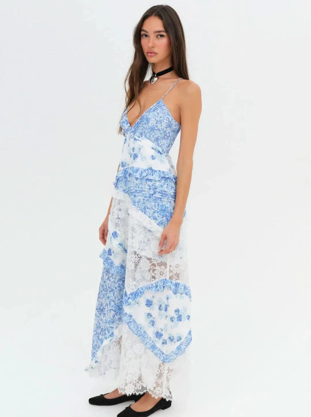 Front view of an Iris Tiered Maxi Dress featuring blue floral print and white lace panels, with spaghetti straps and a v-neckline.