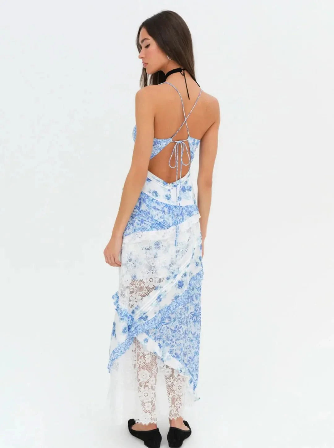 Back view of the blue floral Iris Tiered Maxi Dress, highlighting the criss-cross spaghetti straps and tie-back detail.