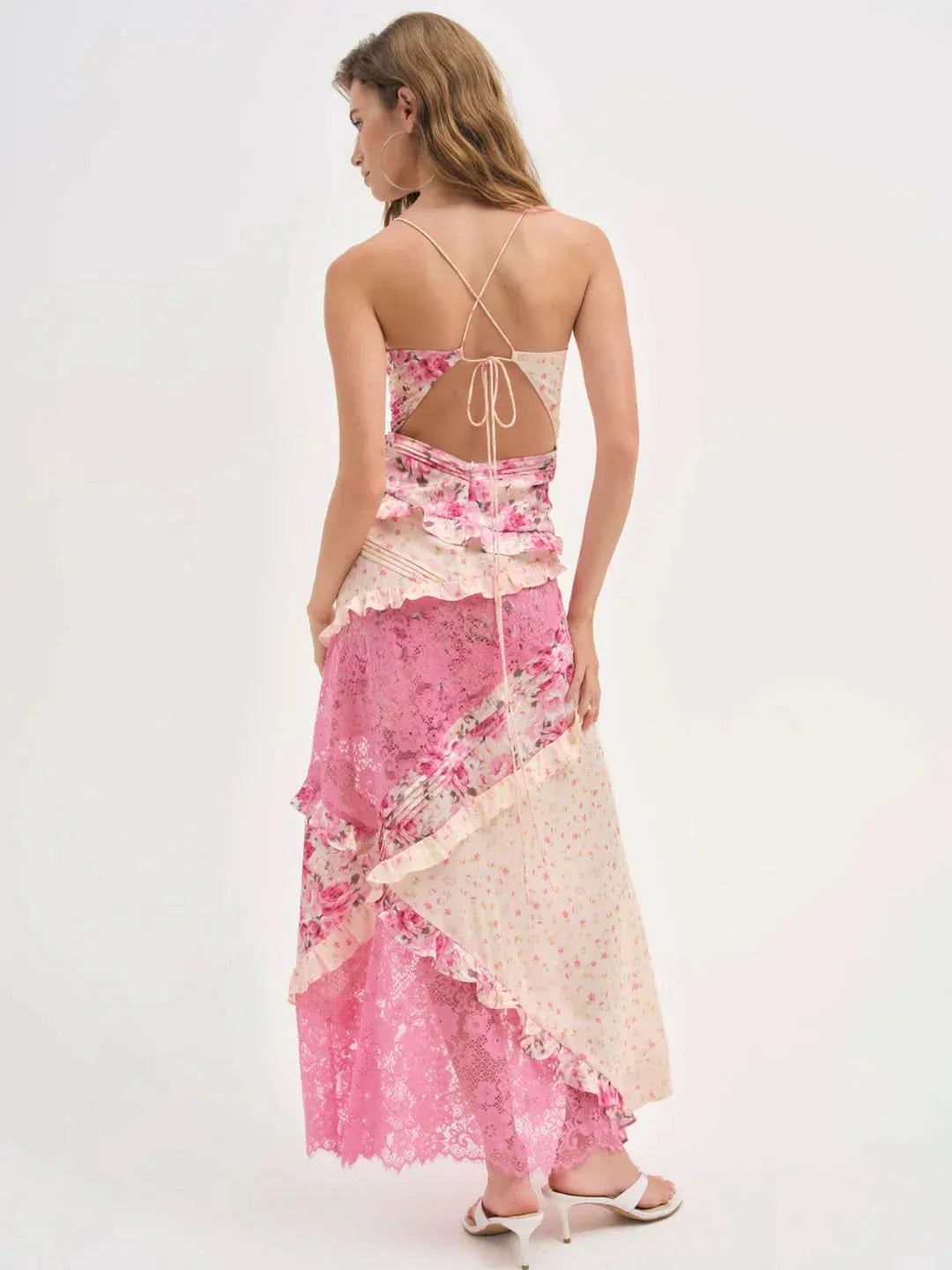 Back view of the Iris Tiered Maxi Dress in a pink floral print with ivory and pink lace panels, featuring a tie-back closure.