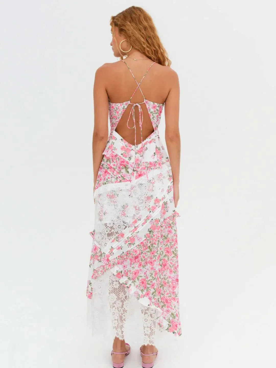 Rear view of the Iris Tiered Maxi Dress in white with delicate pink floral print and white lace sections, showing the criss-cross back.
