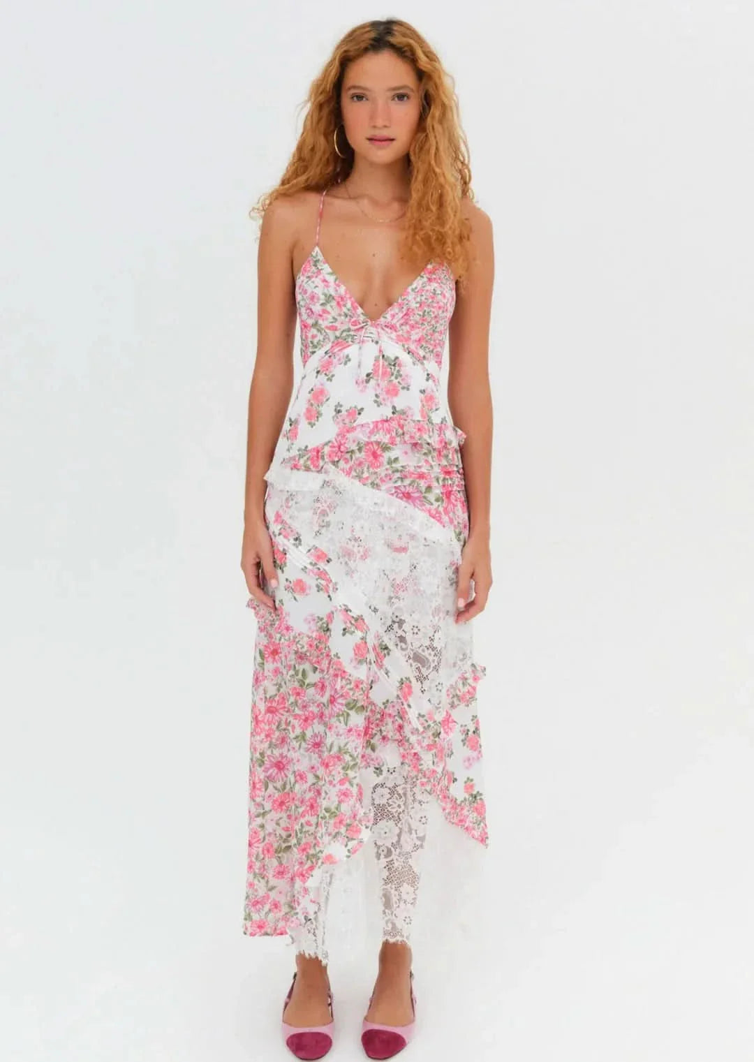 Front view of the Iris Tiered Maxi Dress in white with a charming pink floral pattern and white lace inserts, with spaghetti straps.