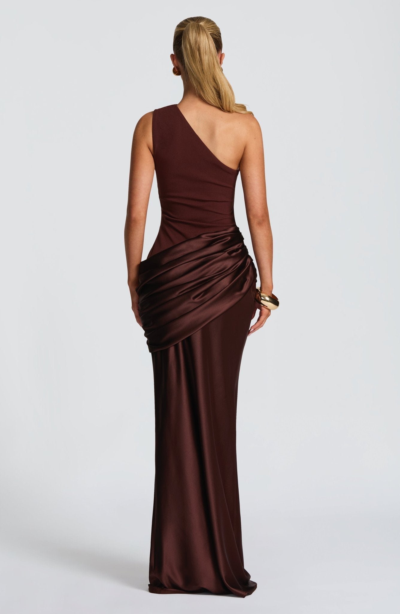 Back view of the brown Isabelle Draped Maxi Dress, revealing the elegant one-shoulder design and the luxurious satin drape.