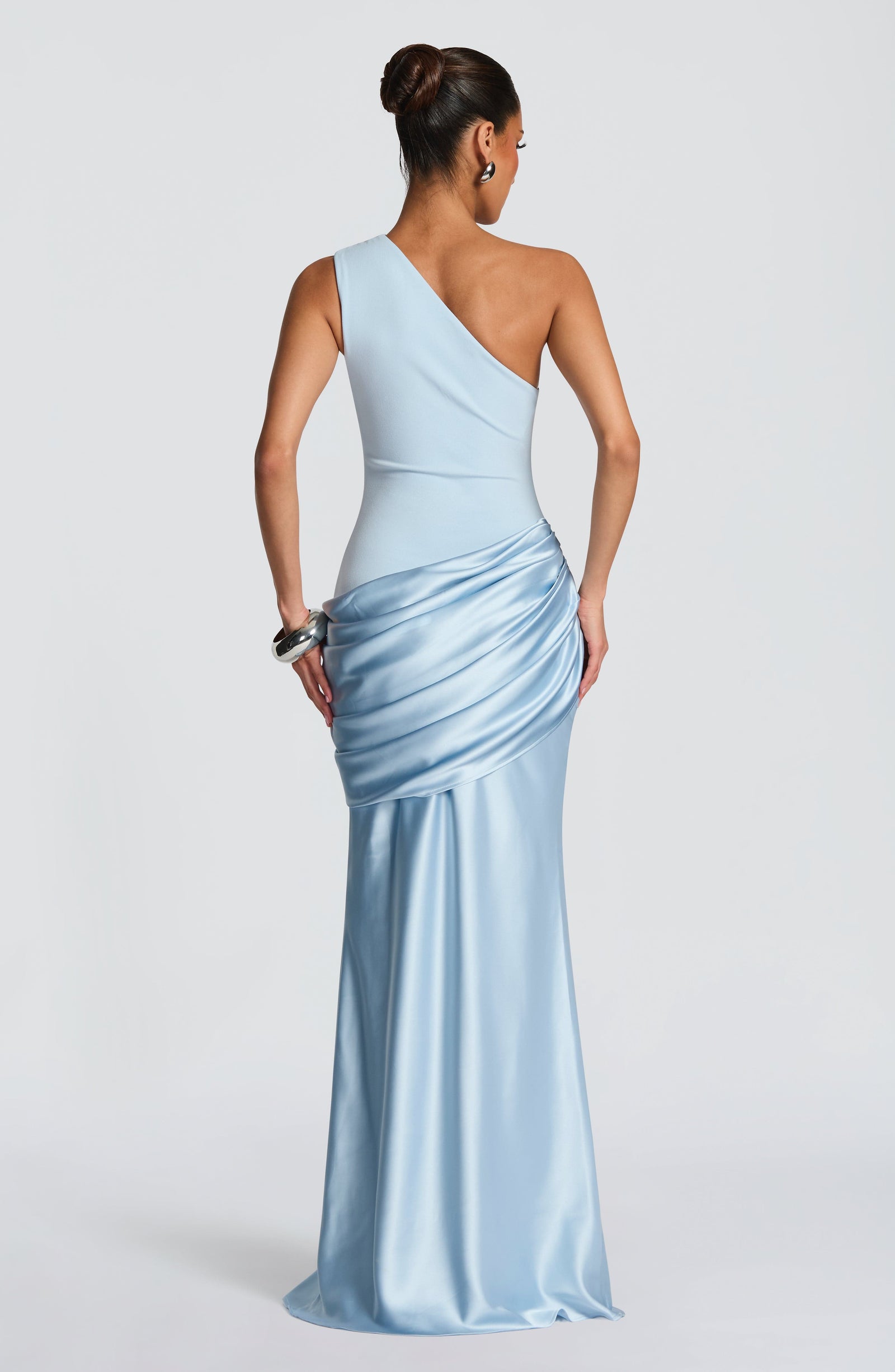Rear view of the light blue Isabelle Draped Maxi Dress, highlighting the one-shoulder design and the elegant flow of the satin fabric.