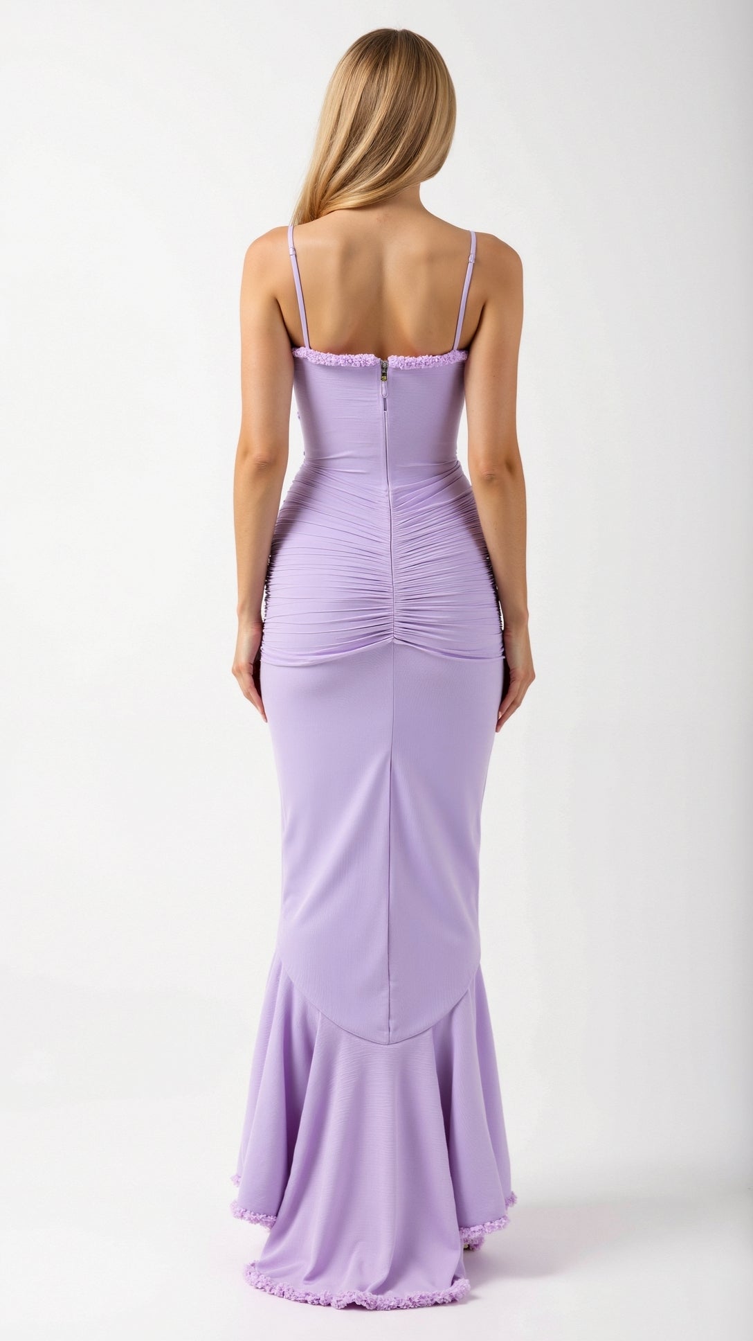 Back view of a woman wearing a lavender Isla Ruffle Maxi Dress with delicate spaghetti straps and gathered fabric on the lower back.