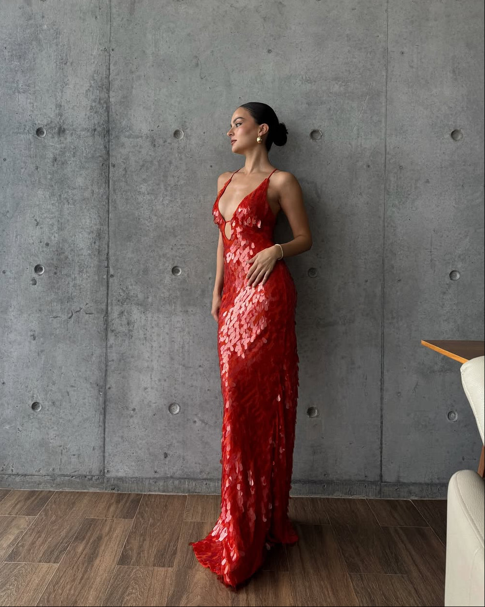 Side profile of the red sequin maxi dress, highlighting the form-fitting silhouette and intricate sequin detailing.