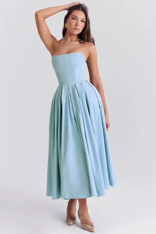 Light blue strapless midi dress with a full, pleated skirt, paired with beige pointed-toe heels, a stylish wedding suit for women.