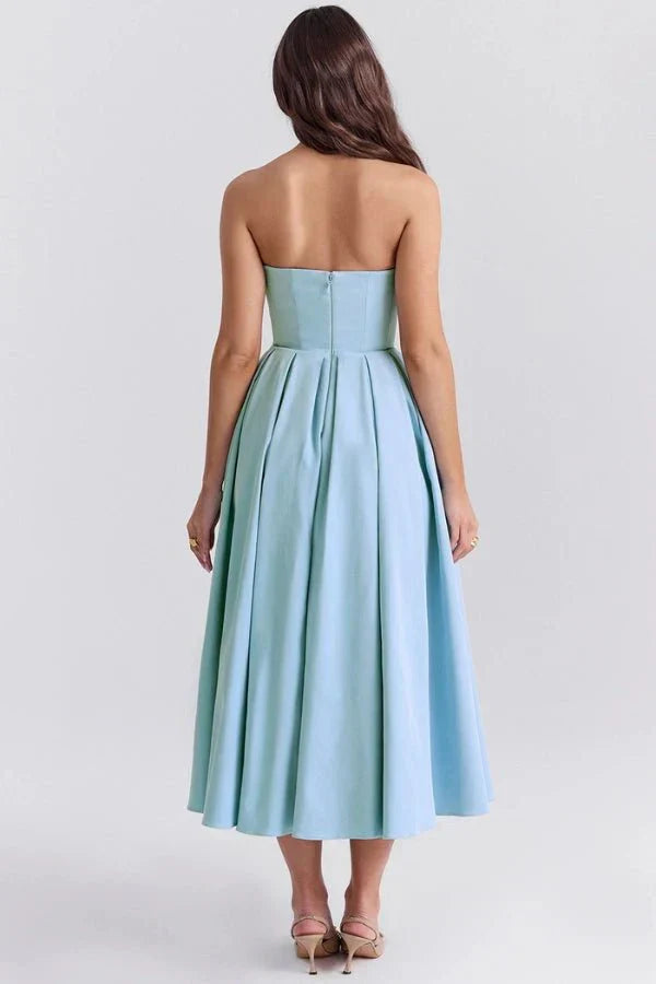 Back view of a light blue strapless midi dress, showcasing the elegant silhouette and discrete back zipper, ideal for wedding suits.