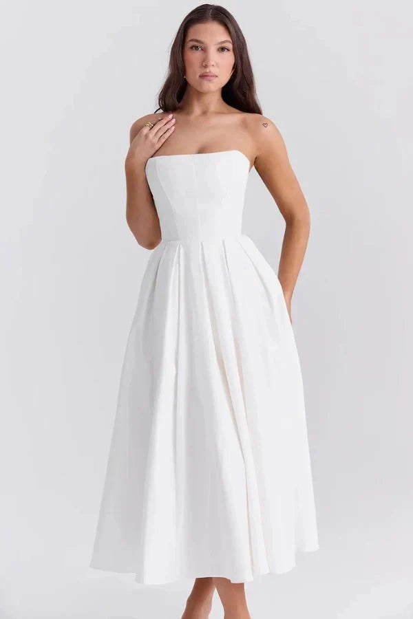 Elegant white strapless midi dress with a structured bodice and flowing pleated skirt.