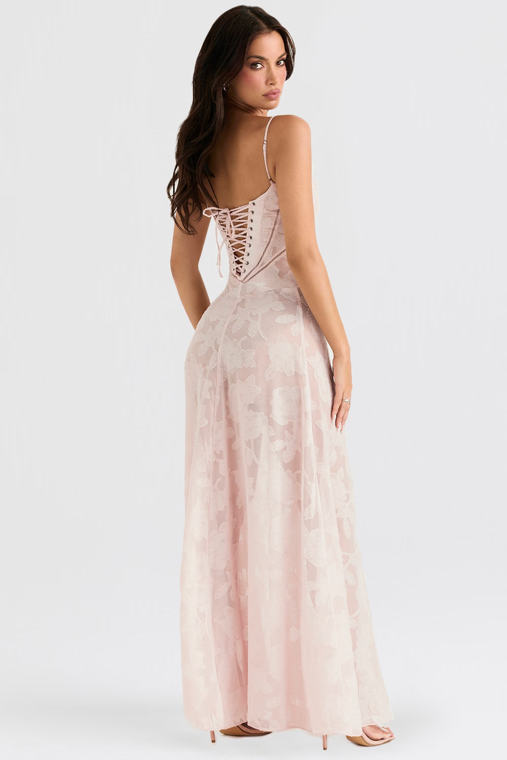 Back view of the light pink Juliet Lace Maxi Dress, featuring a detailed corset-style lace-up back.