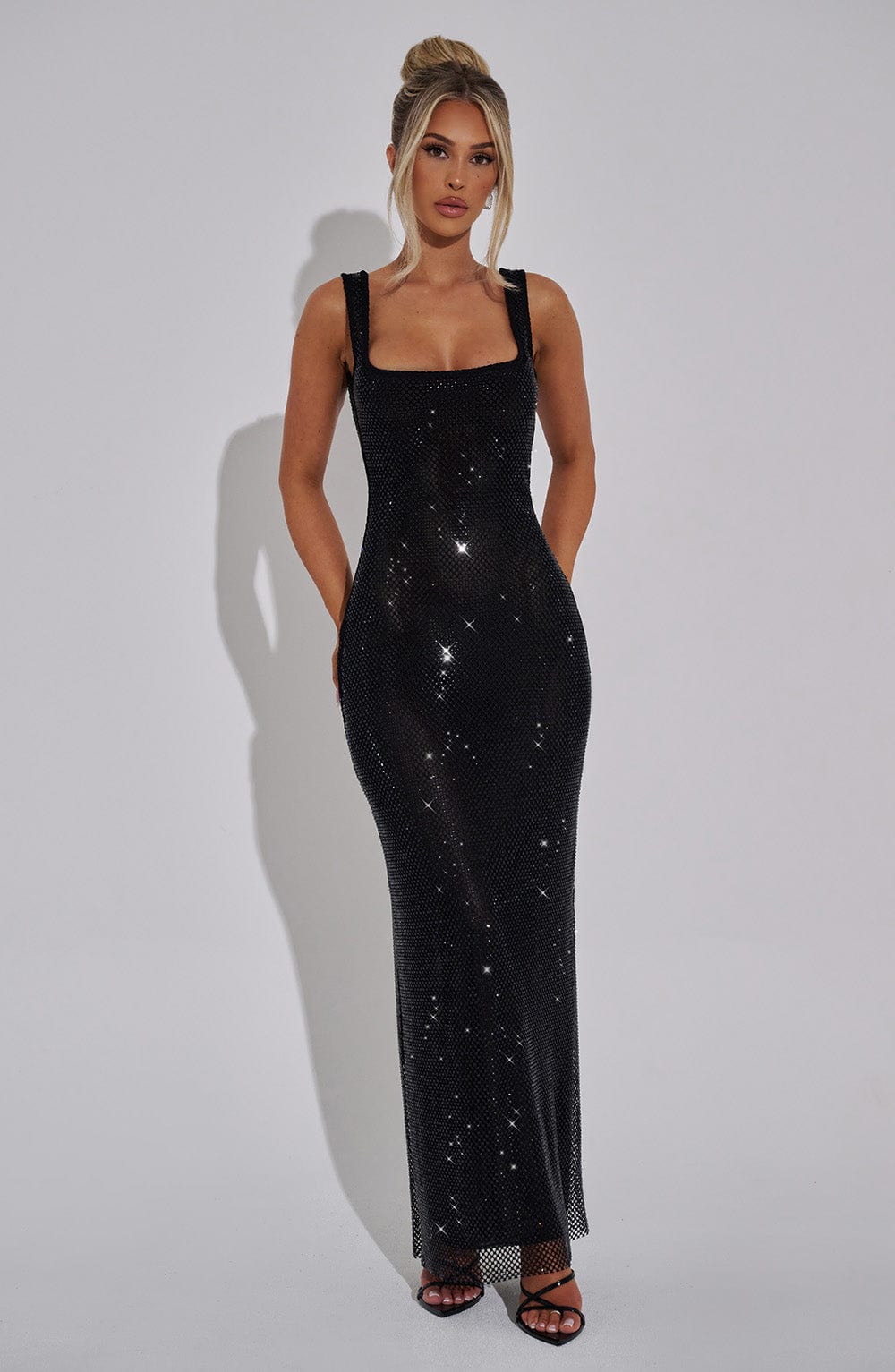 Front view of a shimmering silver mesh maxi dress with square neckline and thin straps, perfect for evening wear.