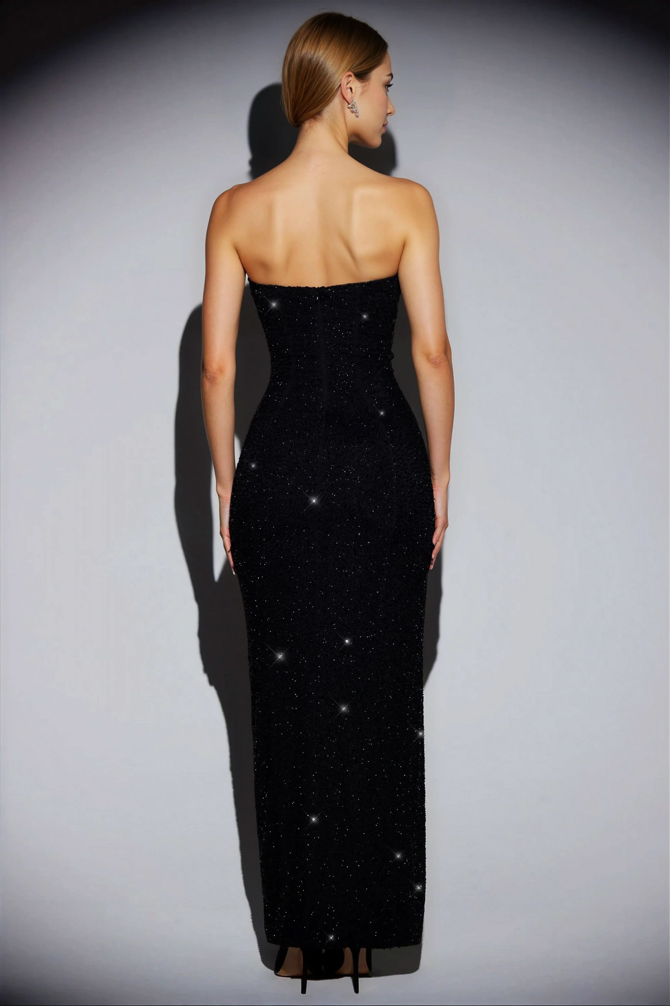 Back view of the black sequin strapless maxi dress, showing the full length and fitted silhouette.