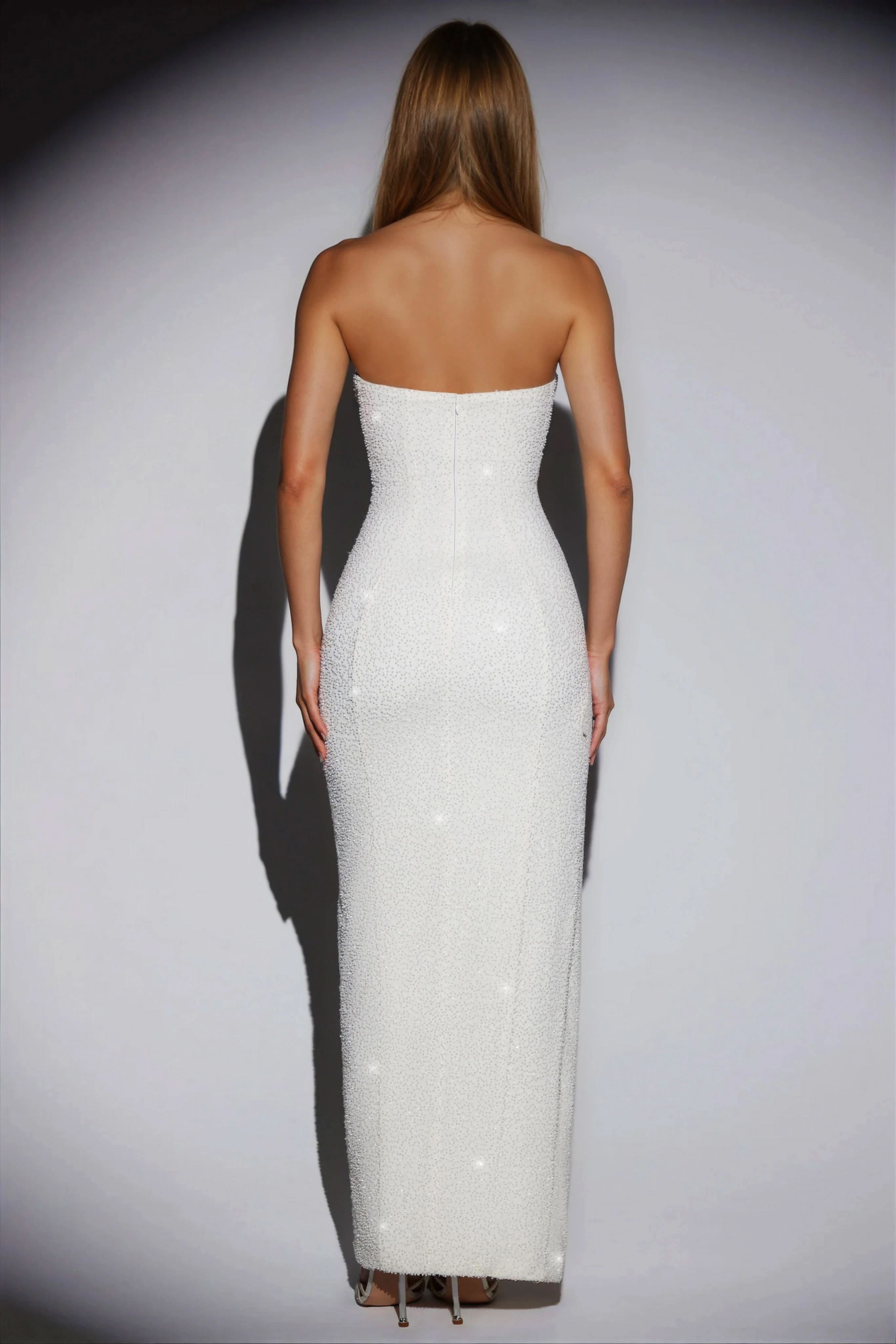 Back view of the white sequin strapless maxi dress, showing the full length and sparkling fabric.