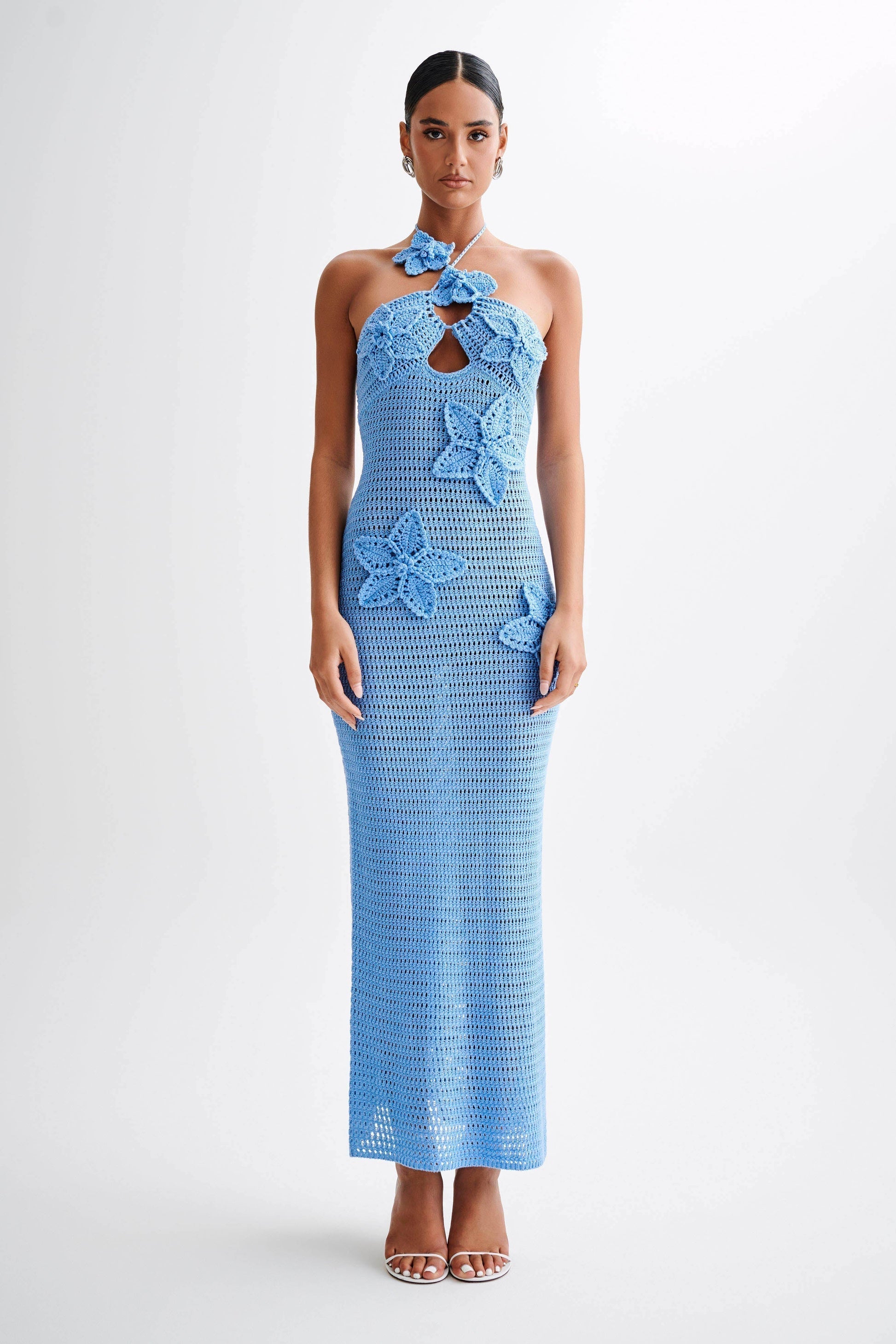 Full length front view of a light blue crochet maxi dress with intricate floral details and a keyhole cutout, ideal for a beach party.
