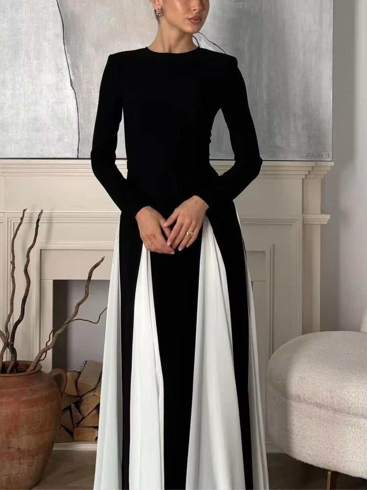 Full length view of a black and white paneled maxi dress with spaghetti straps and sweetheart neckline.