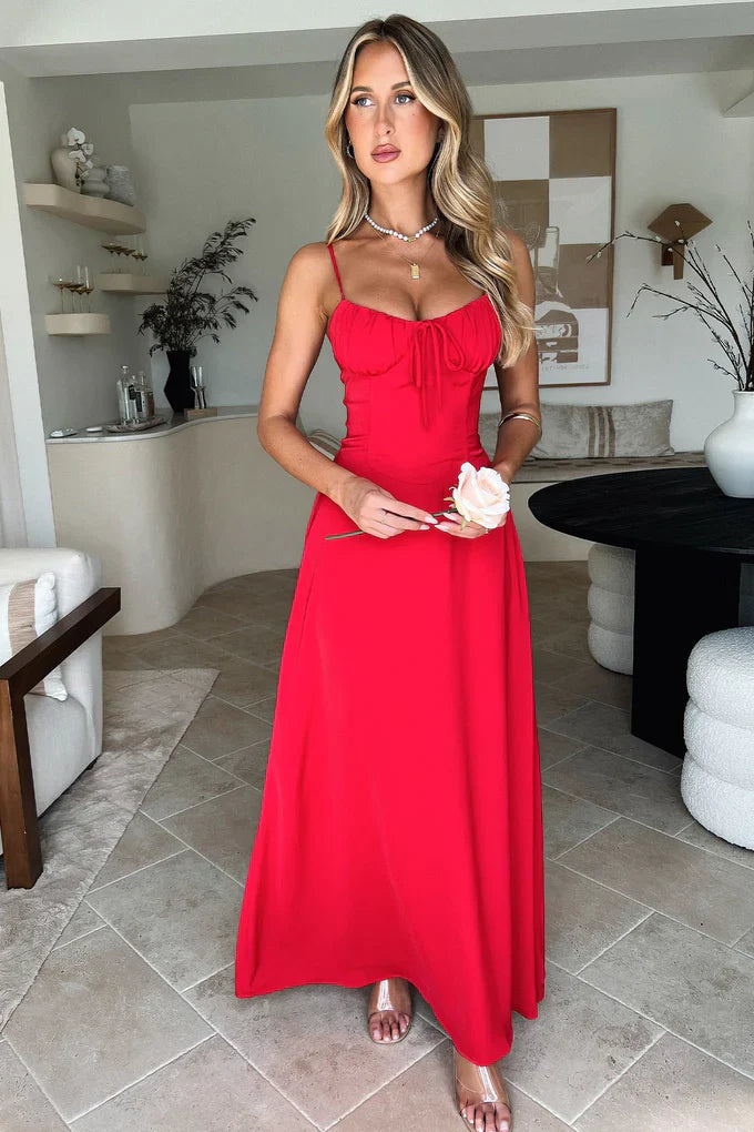 Front view of a vibrant red Kora Ruched Maxi Dress with spaghetti straps and a flattering ruched bodice.