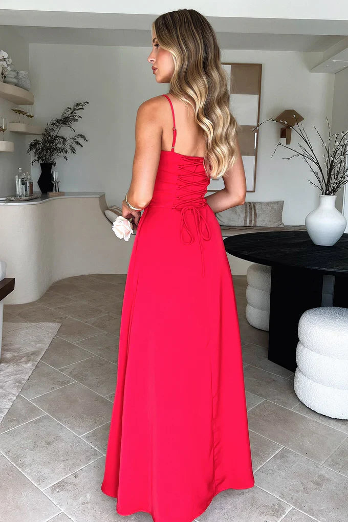 Back view of the red Kora Ruched Maxi Dress showing the lace-up corset detail on the back of the bodice.
