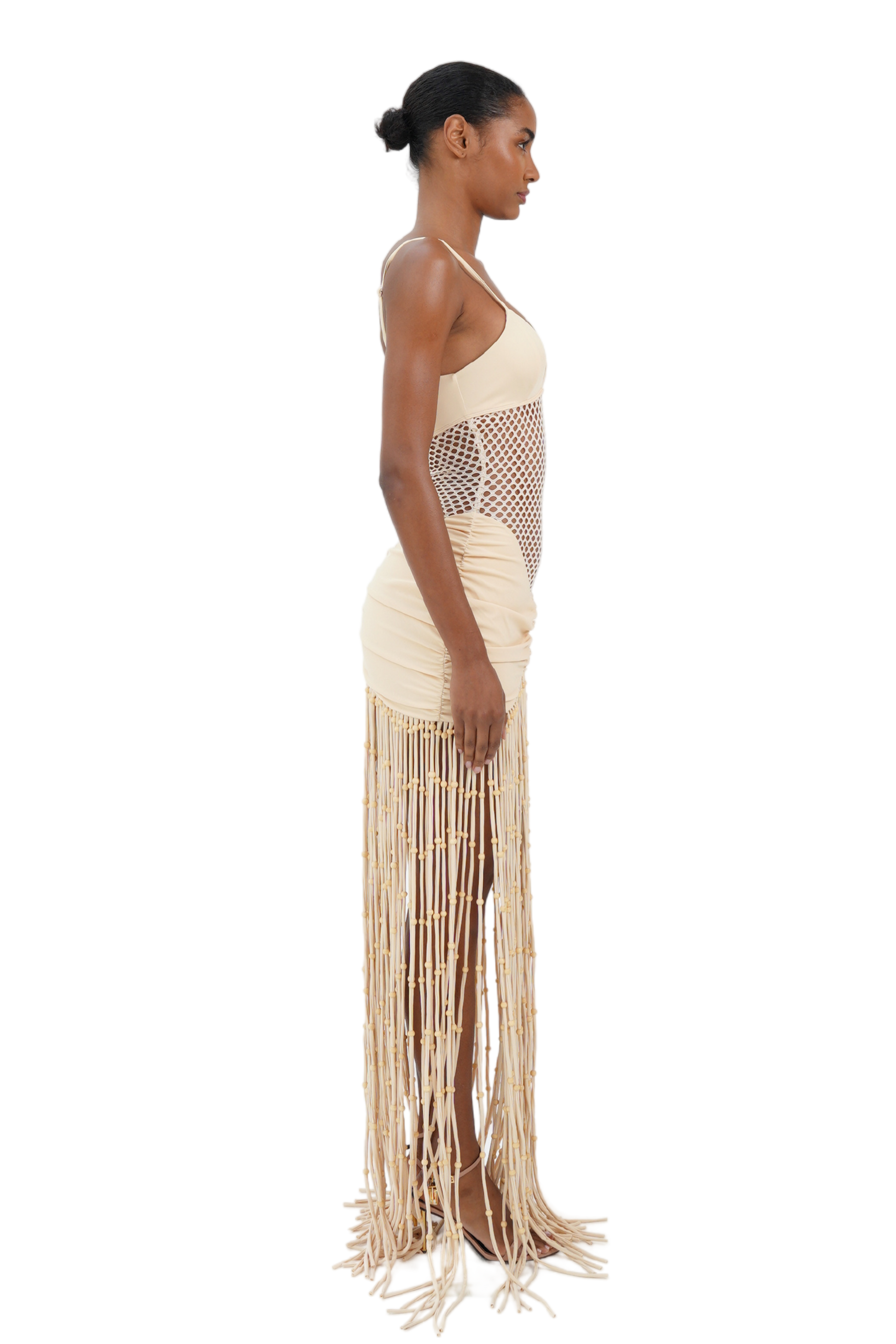 Side view of cream macrame fringe maxi dress with fishnet midsection for women