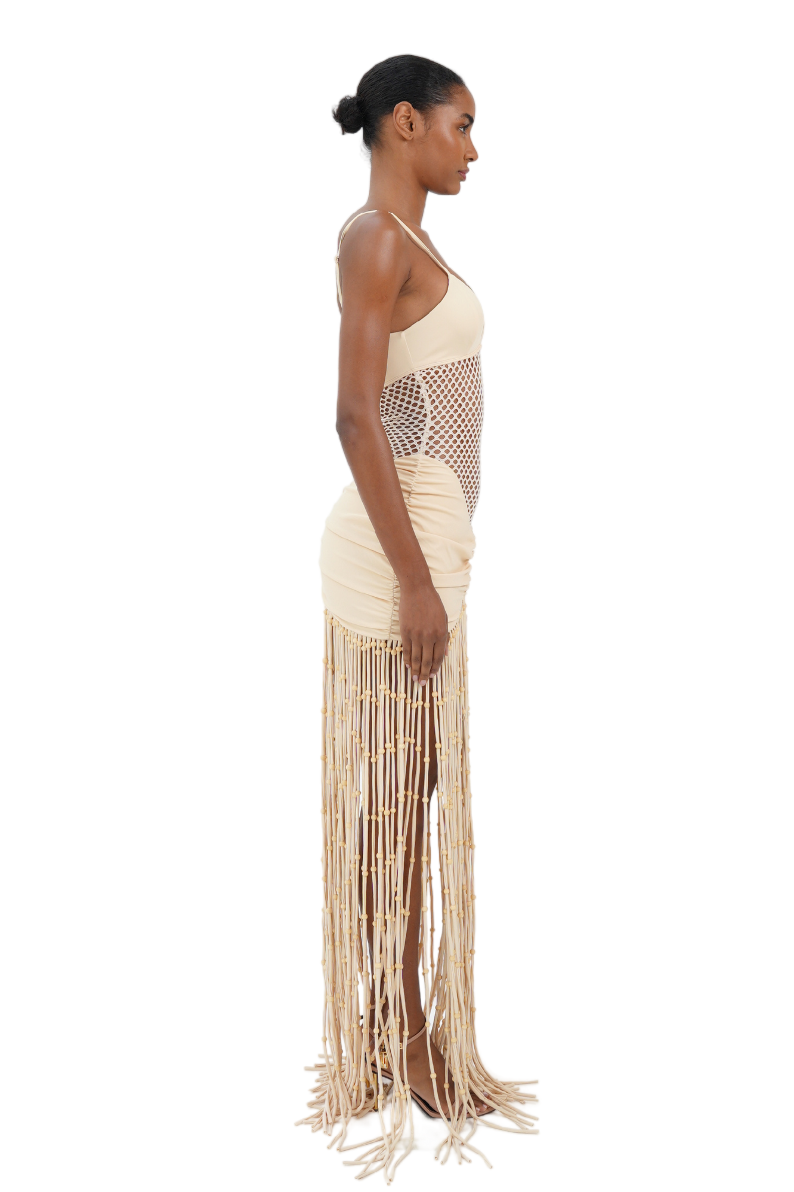 Side view of cream macrame fringe maxi dress with fishnet midsection for women