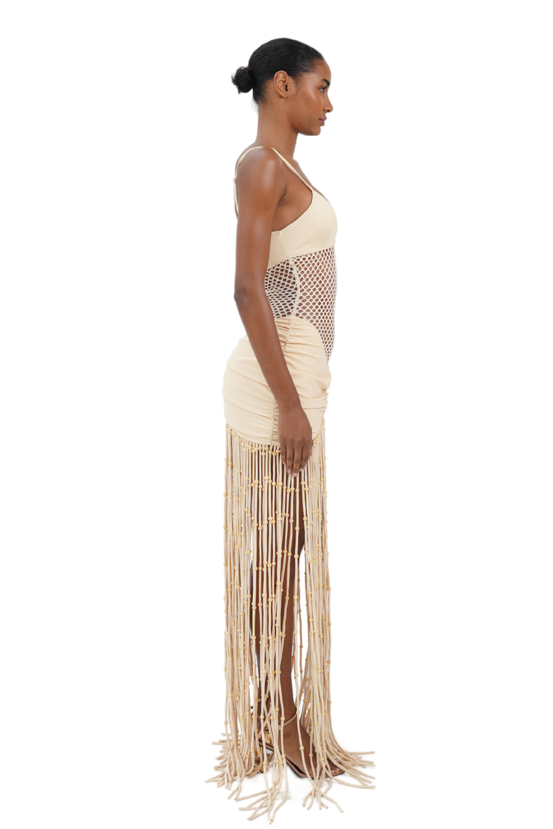 Side view of cream macrame fringe maxi dress with fishnet midsection for women