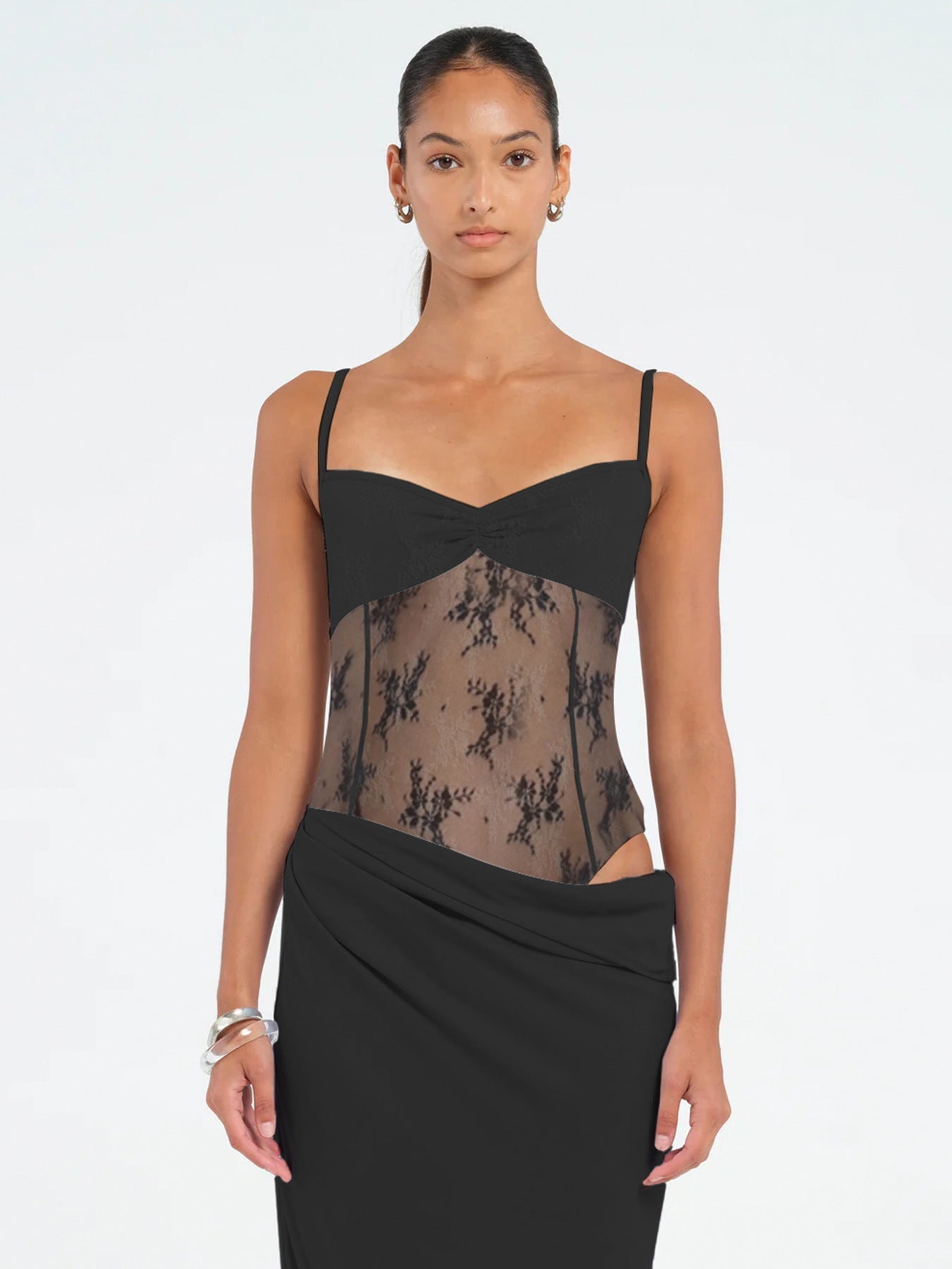 Close-up of black lace maxi dress bodice with sheer floral lace and gathered sweetheart neckline