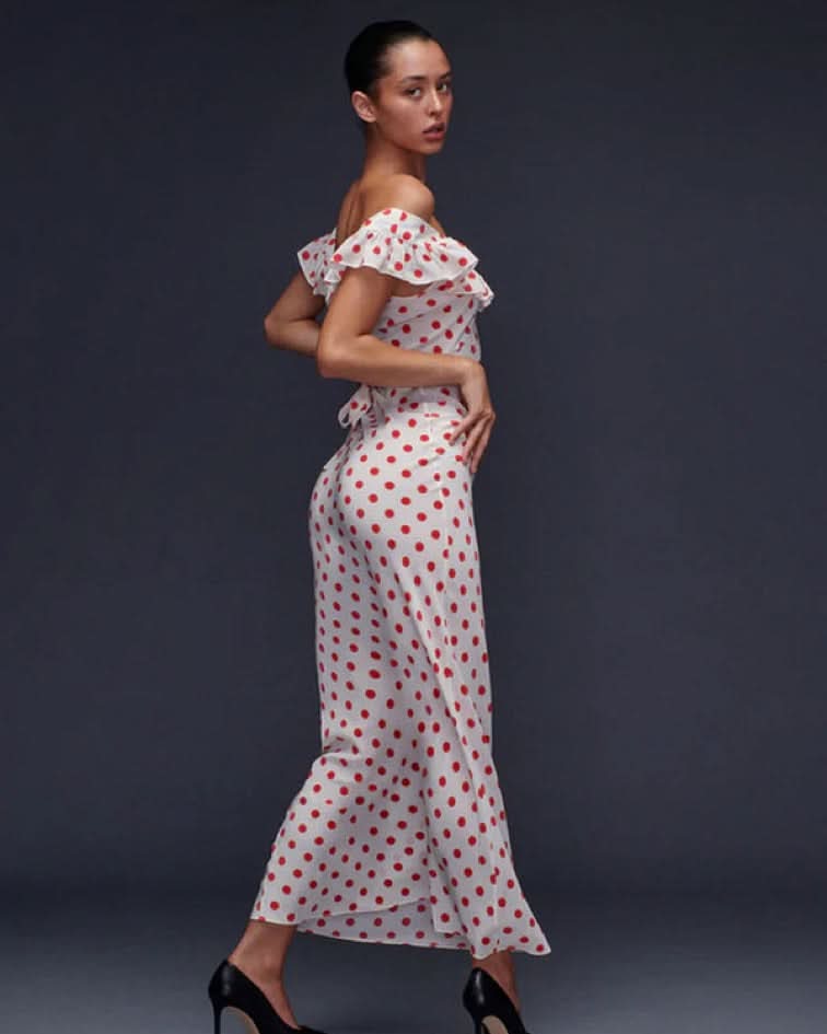 White polka dot maxi dress with off-shoulder ruffle and tie-back detail for women, side view