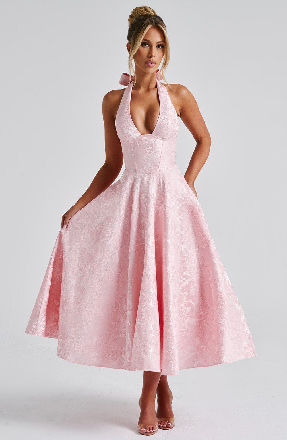 Another front view of the Leilani halter midi dress in light pink, emphasizing the flowy skirt and fitted bodice.