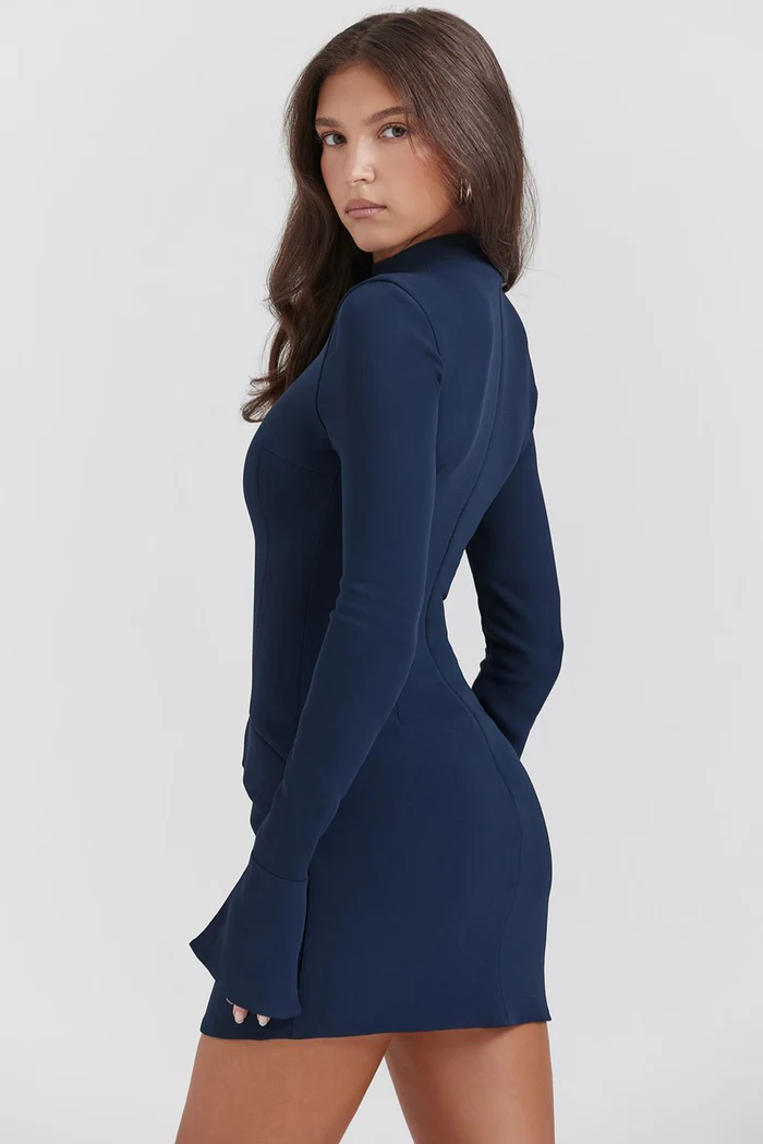 Side profile of a navy blue structured mini dress, highlighting the tailored fit, long sleeves with flared cuffs, and short hemline.