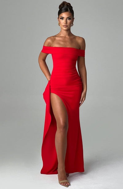 Full front view of a vibrant red Leslie Bardot Maxi Dress with an off-the-shoulder style and ruffled leg slit.
