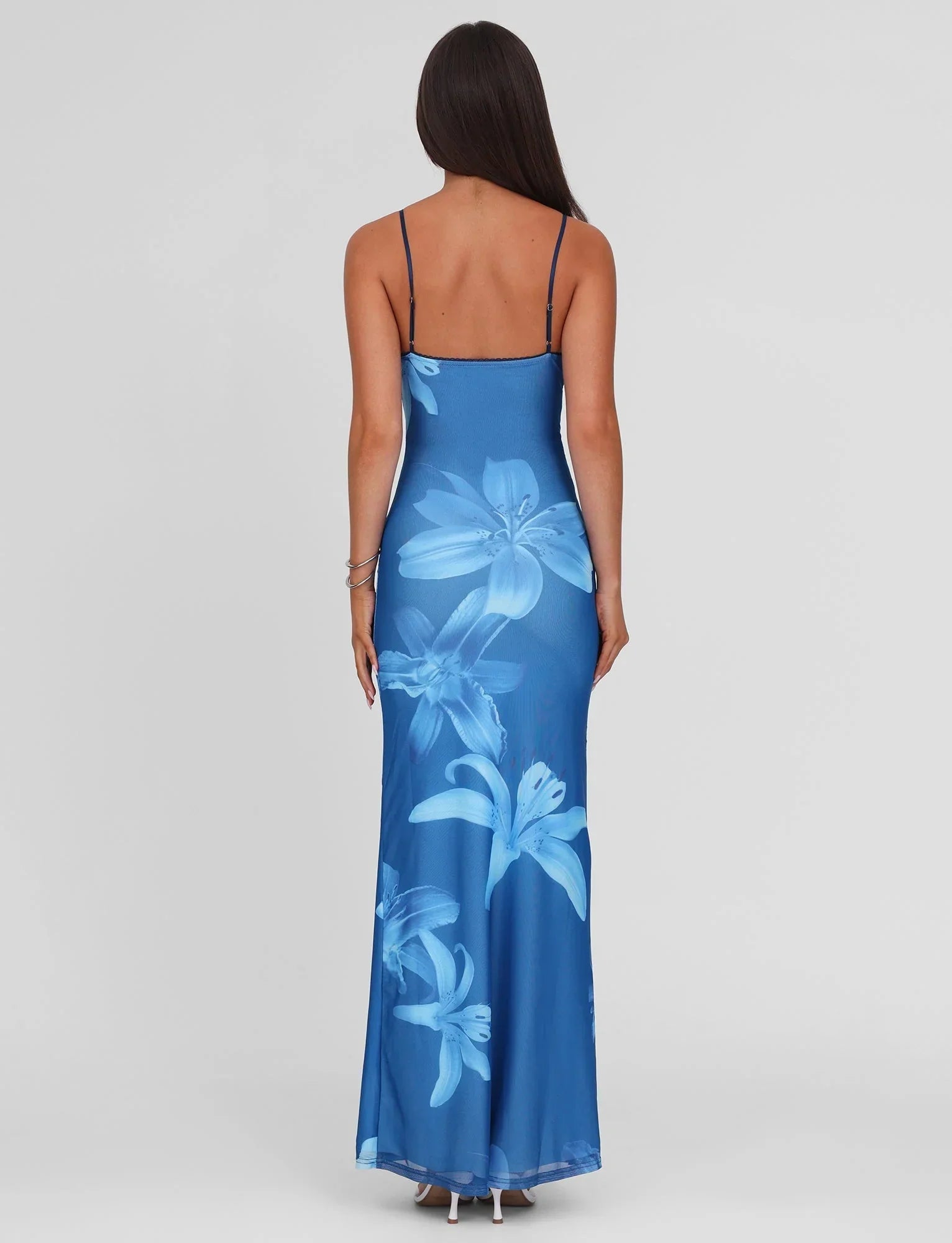 Back view of blue floral maxi dress with open back and thin straps for women