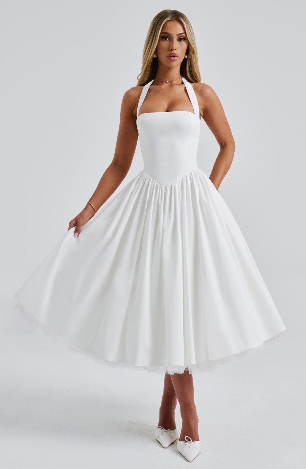 White halter midi dress with square neckline and full pleated skirt, featuring a subtle tulle underskirt.