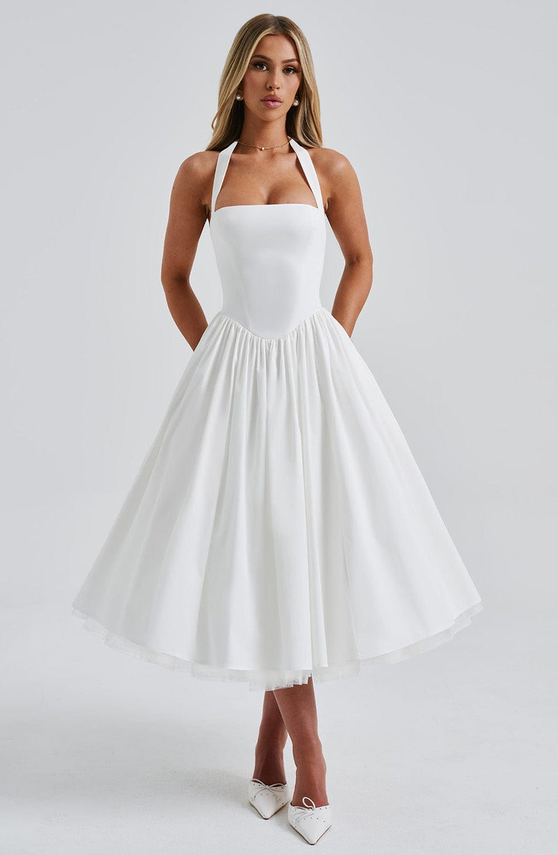 White halter midi dress with square neckline and full pleated skirt, featuring a subtle tulle underskirt.