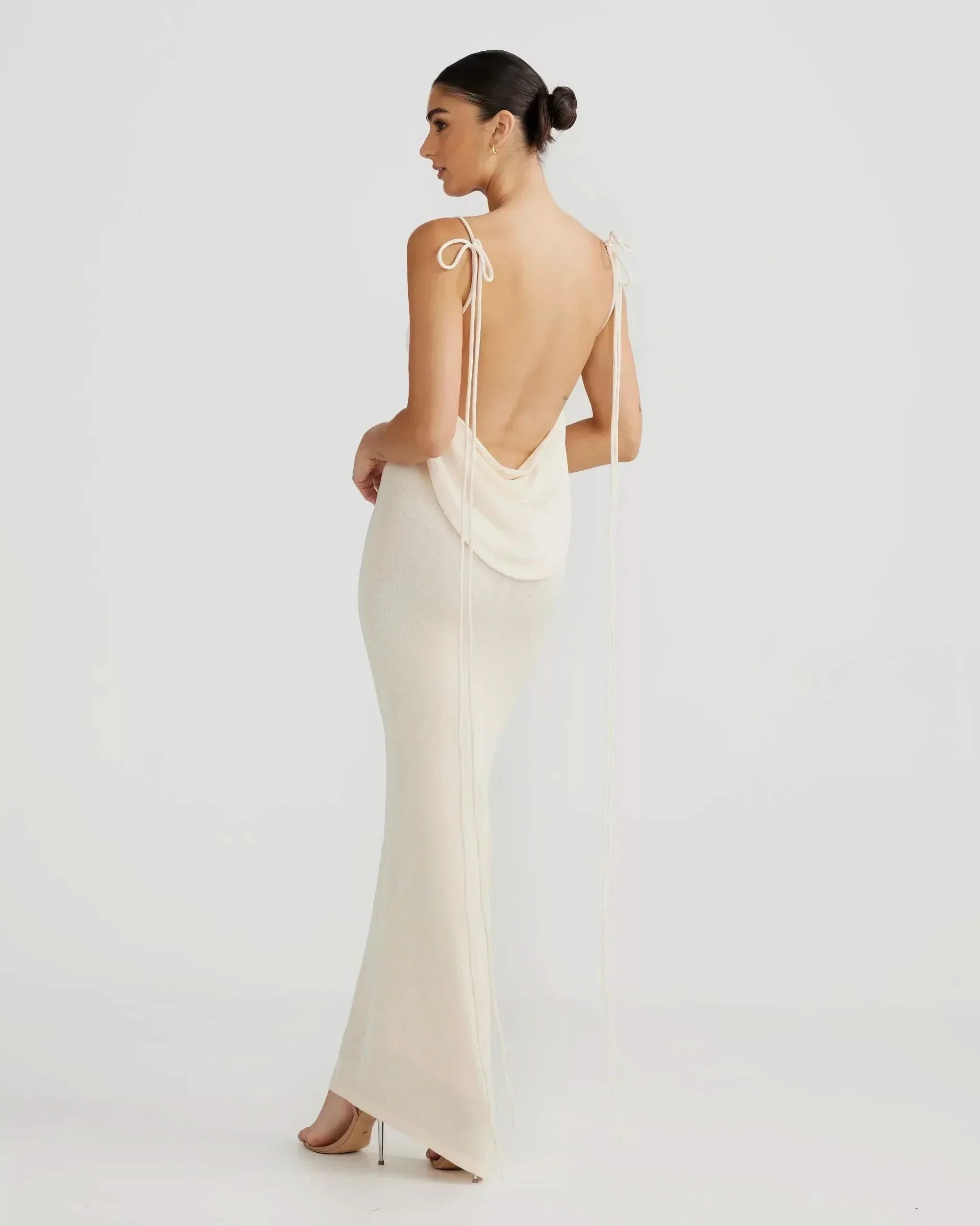 Off-white backless cowl neck maxi dress with long tie straps on a model, back view for women