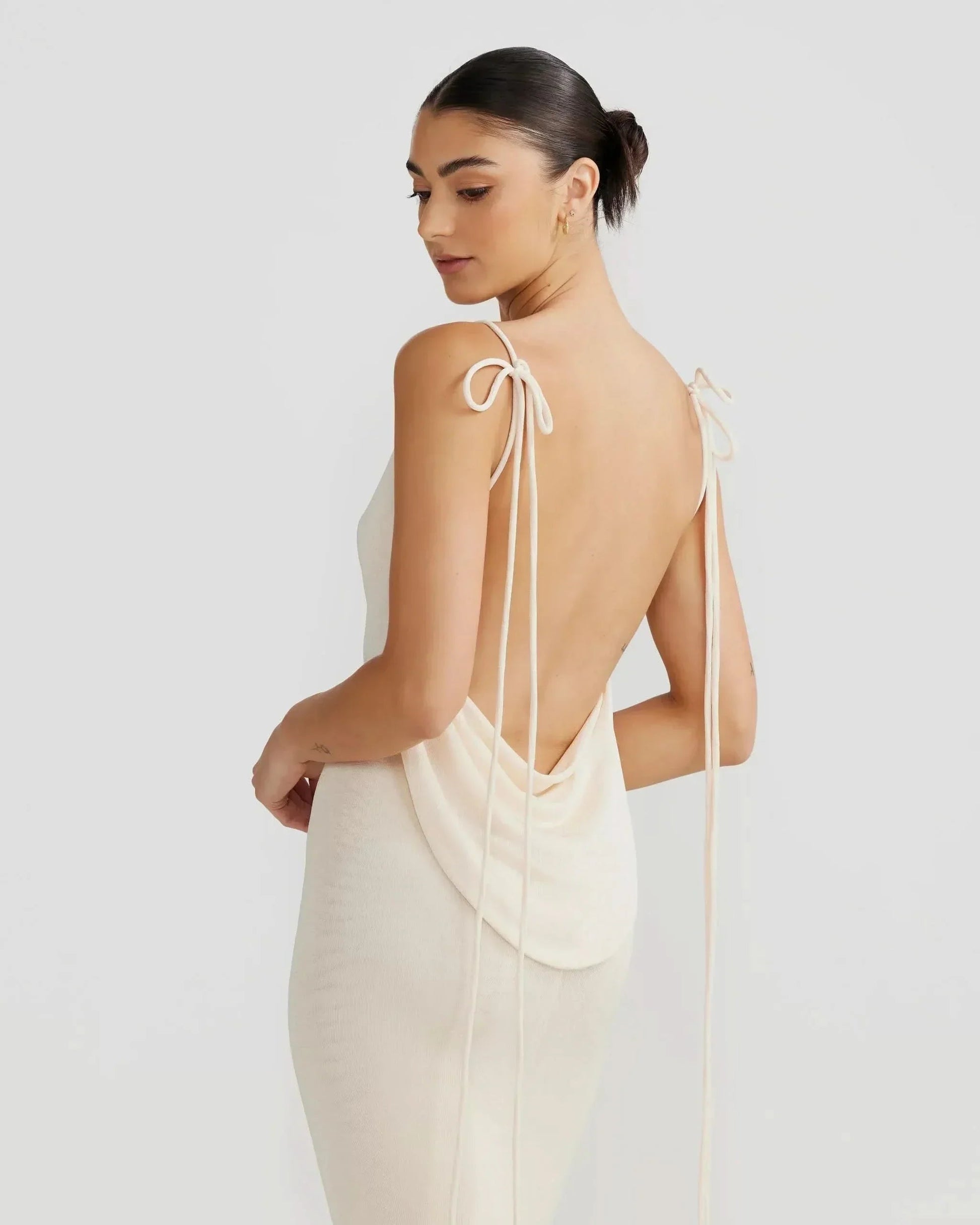 Detail of off-white backless maxi dress showing draped cowl back and tied shoulder straps for women