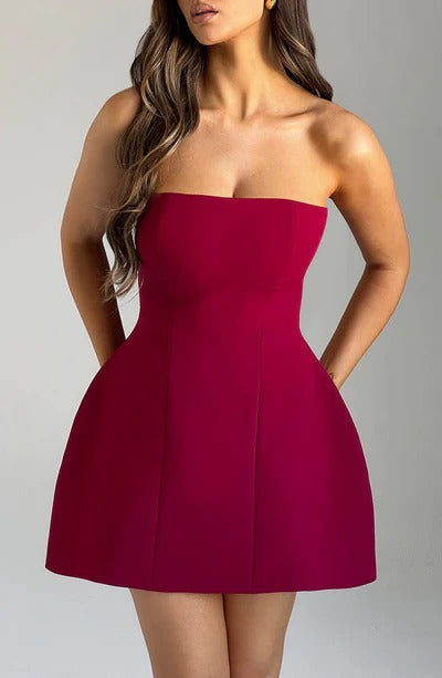 Close-up front view of a woman wearing a rich red strapless Lola Bubble Mini Dress, emphasizing the bodice detail.