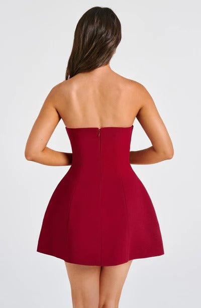 Back view of a woman in a deep red strapless Lola Bubble Mini Dress, showing the flattering cut and mini length.