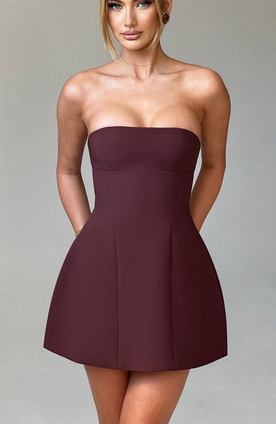 Front view of a rich brown strapless mini dress, featuring a structured bodice and a playful bubble skirt design.