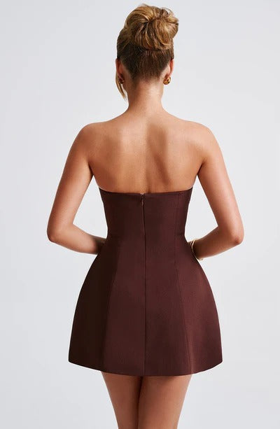 Back view of the brown strapless bubble mini dress, showcasing the tailored fit and the subtle texture of the fabric.