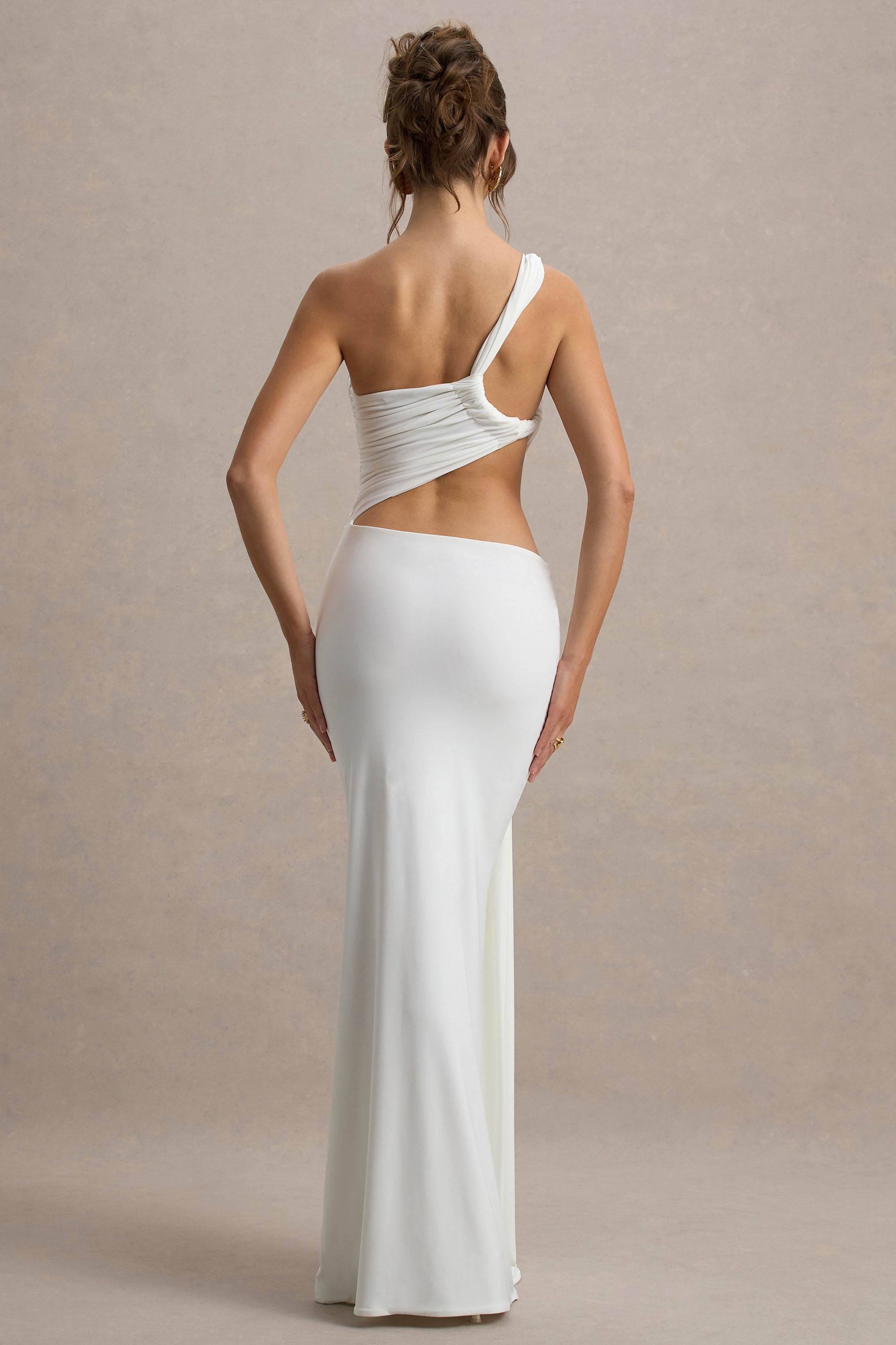Back view of the white Lorelei Cutout Maxi Dress, featuring the unique back strap design and the smooth, flowing maxi skirt.