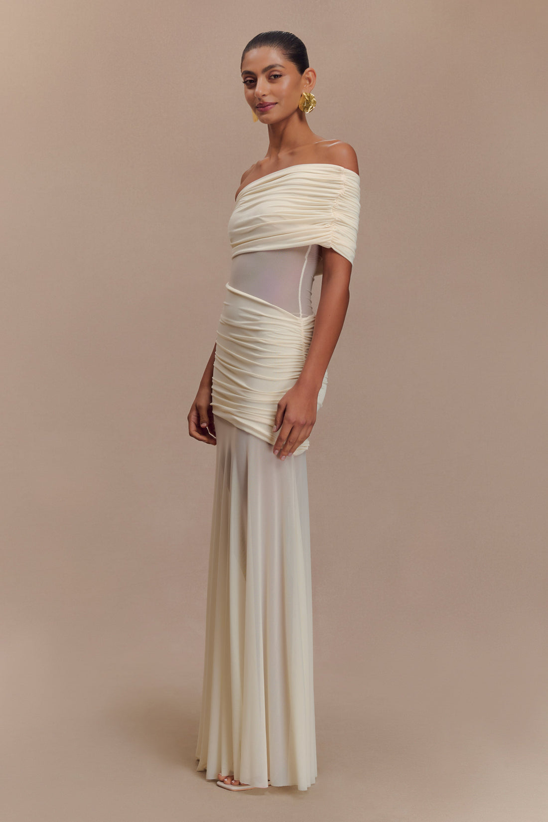 Full-length black Luella cutout maxi dress with sheer mesh panels and ruched off-the-shoulder design, front view.
