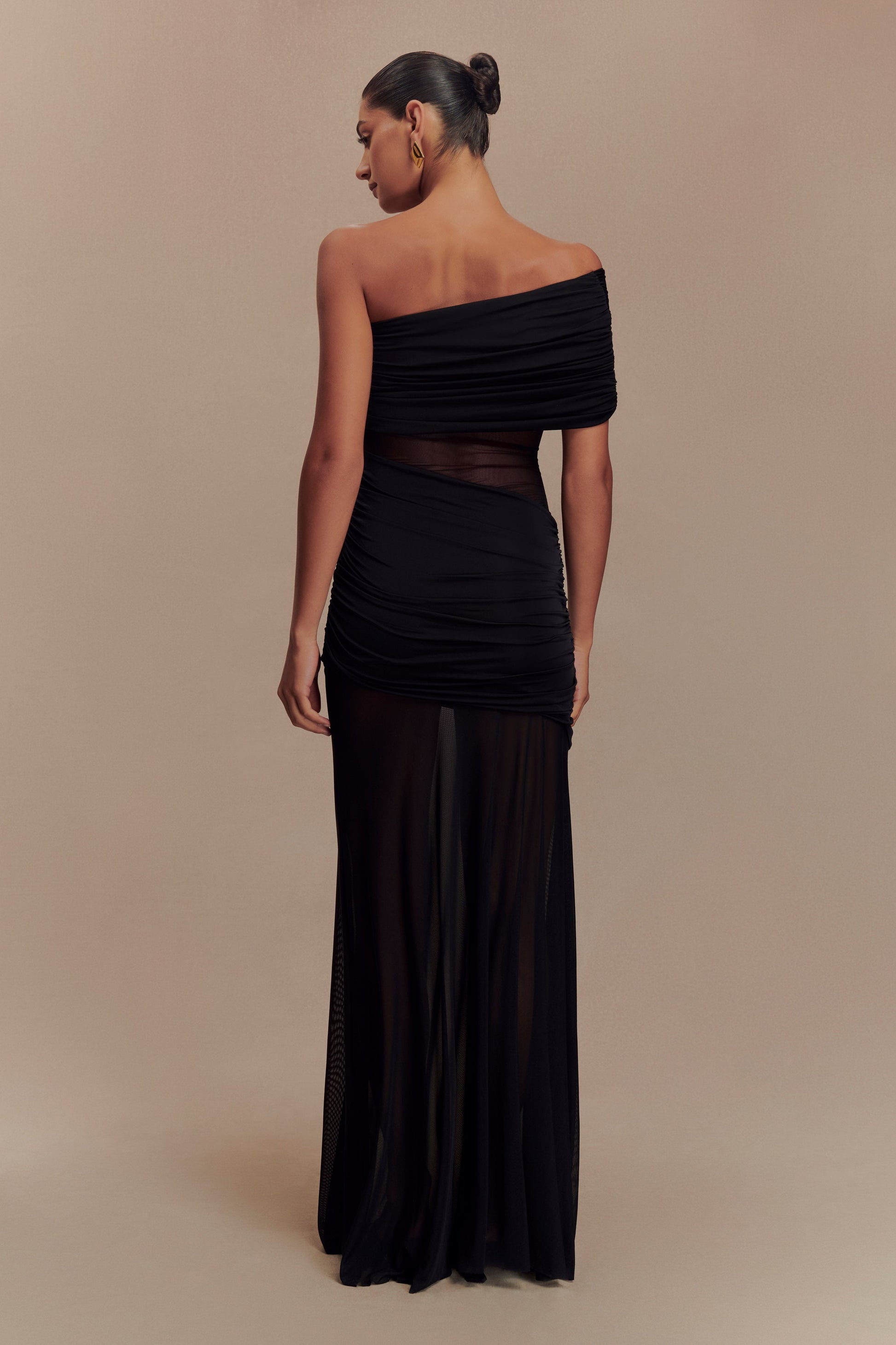 Back view of the black Luella cutout maxi dress showing the sheer mesh paneling and ruched detailing.