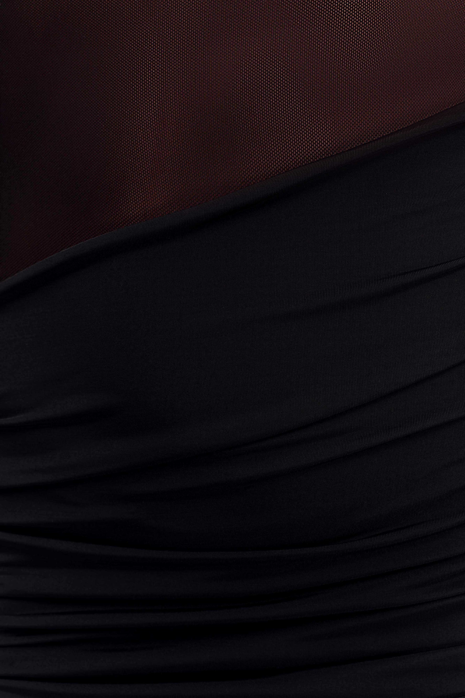 Close-up detail of the black Luella maxi dress showing the textured ruching and sheer mesh cutout fabric.